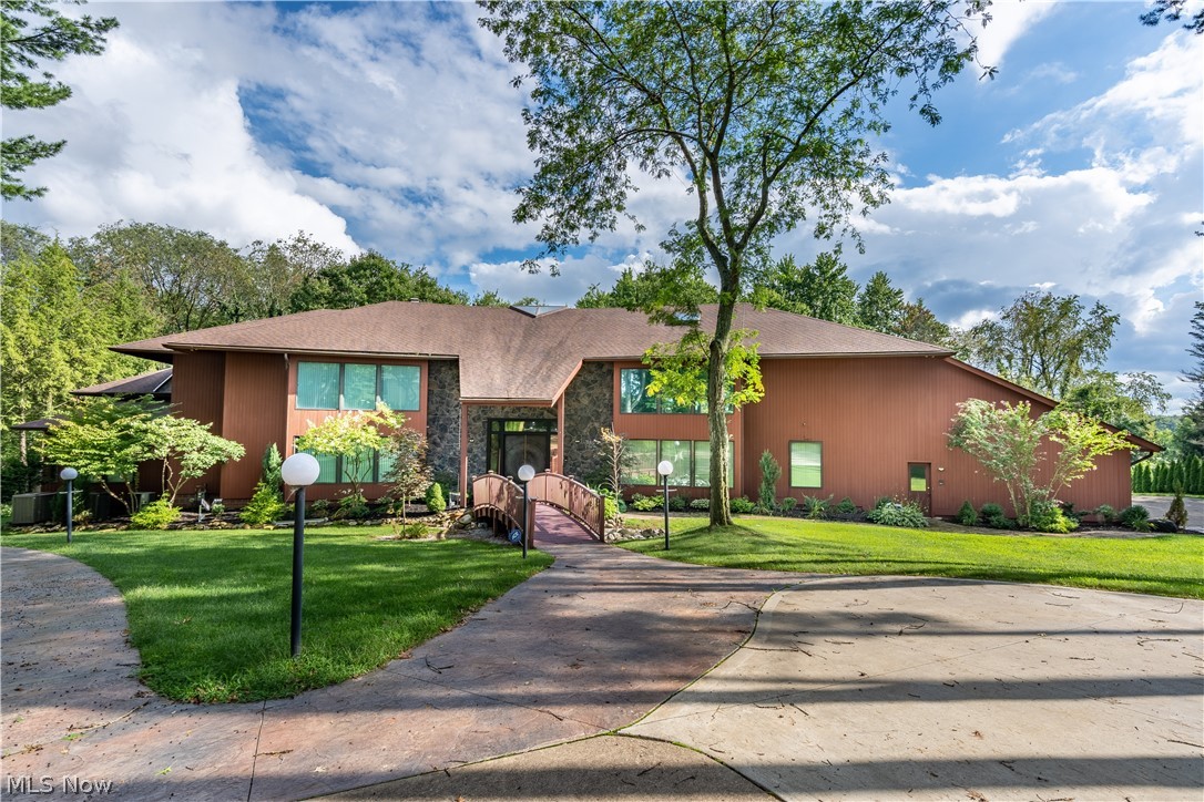Tucked away in Thistlehill Village, sits a 13,000 sqft, 5-bedroom, 7-bathroom charmer, in a cul de sac street. A neatly manicured lawn, and a paved walkway leads to the double front doors of this unique Contemporary/Modern home. The 37 foot grand foyer with marble floors opens up to a beamed ceiling and beautiful windows that overlook 2 acres. This quality built home also has a fountain that enhances the home's entrance with a LED lighting system. The kitchen offers a large center island, granite countertops, and stainless steel appliances. All rooms upstairs are generously sized, have carpet flooring throughout and include built in closets. The master bedroom has an oversized jacuzzi tub with marble flooring, a private library, fireplace, and a large walk in closet. This home also features an indoor pool with a retractable cover, a hot tub, and cedar beamed ceilings that all walk out to a beautiful deck. The finished lower level includes a dance floor, a wet bar, movie theatre, game room, workout area, and a full kitchen making it the perfect place to entertain. This home truly has it all. Schedule a showing today!
