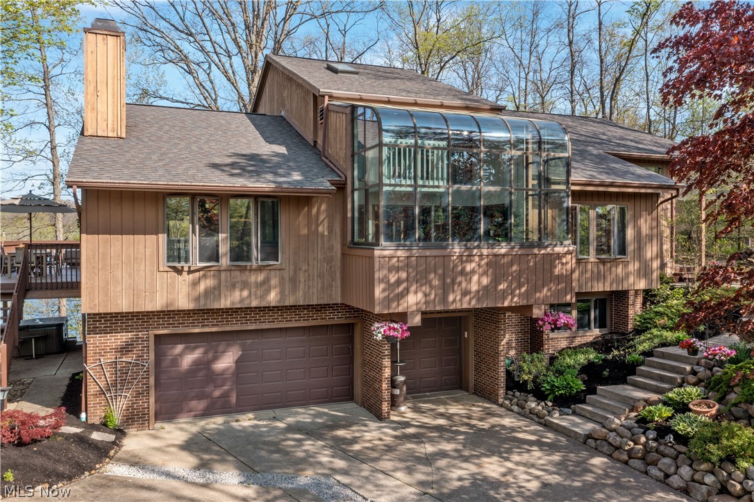 Here is your once in a lifetime chance to live on Lake Medina.  One of only about 20 homesites that touch the lake, this contemporary home boasts incredible views of the lake from many rooms.  There is a large deck and just steps from the lake is a quaint gazebo to enjoy or you can always pop into the hot tub (staying) to relax.  The home has been updated in the last 6 years highlighted by the kitchen with new Kraftmaid cabinetry, tile backsplash, granite counters, stainless appliances and eat in island with an Electrolux cooktop and working desk.  Cozy family room with built ins and wood burning fireplace with gas assist.  Huge dining room/additional living room with 2 story walls with custom painted design opens up to a full two story solarium for a serene space that overlooks the development's large front lake.  5 bedrooms and 4.5 baths (2 bedrooms and 1.5 bath on main floor), the master bedroom (with large master bath with oversized vanity and closet) and two additional bedrooms (w