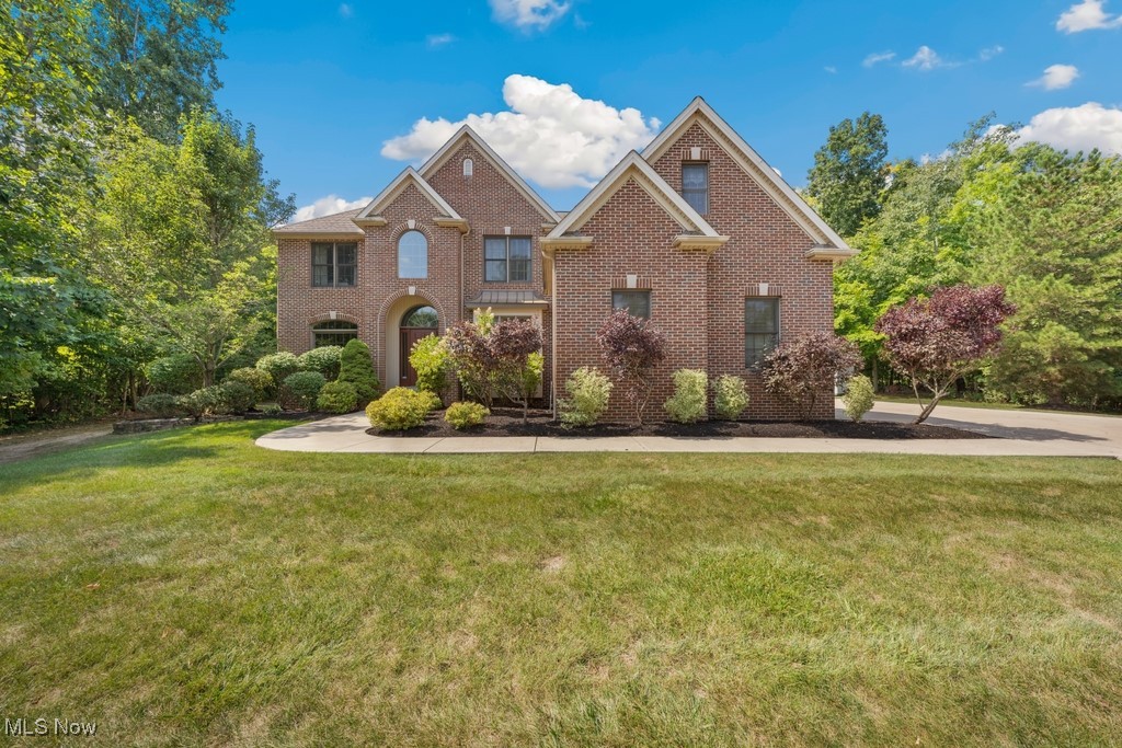 Welcome to 17478 Waterbridge Dr, a stunning 5-bedroom, 4-bathroom home situated on a beautifully landscaped 1+ acre lot in the prestigious Pinestream subdivision of North Royalton. This one-of-a-kind property offers privacy on three sides, providing a tranquil retreat while being just minutes from local amenities. Boasting over 4,000 square feet of meticulously renovated living space, this home was fully updated in 2018 and 2019, with new carpet added to the finished basement in 2024. A standout feature of this home is the convenient first-floor bedroom, perfect for guests or multi-generational living. The heart of the home is the spacious, open-concept kitchen, outfitted with high-end appliances, custom cabinetry, and sleek countertops. It flows seamlessly into the living areas, making it ideal for both entertaining and everyday life with a beautiful fireplace. Upstairs, you’ll find an inviting master suite with a second fireplace and additional bedrooms, all offering comfort and luxury. Enjoy peaceful mornings or host gatherings on the expansive patio overlooking your private backyard oasis. With its perfect blend of modern updates and timeless design, this home offers the best of both worlds. Located in the highly desired North Royalton school district and close to parks, shopping, and more, 17478 Waterbridge Dr is a rare opportunity to own a truly exceptional home. Don’t miss out!