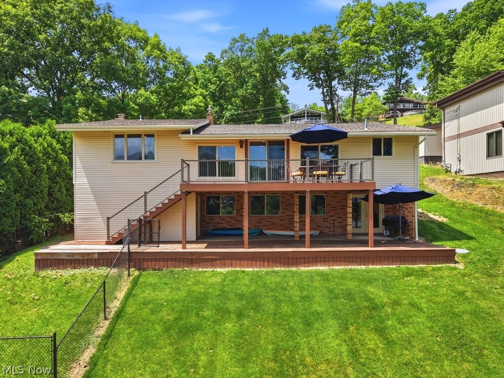 Gorgeous updated lakefront home situated on a wide waterfront lot with beautiful lake views and plenty of space for entertaining both indoors and out. This move-in ready home now offers 4 bedrooms and 3 full baths, including 2 full baths on the main level. The open kitchen and living room provide stunning lake views and lead directly to a composite deck overlooking the water. The main-level owner's suite features lake views, a walk-in closet, and a sitting room or office with a woodburning fireplace. Two additional bedrooms and a full bath complete the main floor. The walkout lower level offers a spacious family room, a newly created fourth bedroom, full bath, designated laundry room with storage closet, and access to the patio and lakeside entertaining areas. The outdoor living spaces are exceptional with a large yard perfect for summer games, a new stamped concrete patio with gas firepit at the lake, two newer docks, an upgraded seawall, and water and electric service at the waterfront. Additional features include solid doors throughout, a recently waterproofed lower level, WiFi thermostat, Lennox furnace and central air installed in 2025, electric vehicle charging hookup in the garage, fenced pet area, and a large storage room conveniently accessible from both the garage and lower-level deck area. Car enthusiasts and lake lovers alike will appreciate the 4-car garage, concrete driveway, and additional parking area at the top of the driveway. Enjoy all the amenities of Lake Mohawk, including a 500-acre private lake with unlimited horsepower boating, three beaches, tennis and pickleball courts, playgrounds, clubhouse, and a 9-hole golf course with separate membership available. Start making lake memories today in this exceptional waterfront home.