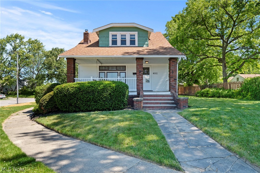 Welcome home to this absolutely darling bungalow nestled in one of Parma's charming sidewalk-lined neighborhoods! Relax and unwind on the inviting front porch, complete with a classic porch swing, the perfect spot to enjoy your morning coffee or evening breeze. Inside, you'll fall in love with the timeless character and warmth of this century home. Beautiful hardwood floors flow throughout, while original built-ins add charm and functionality at every turn. The cozy country-style kitchen offers plenty of character and a welcoming space for everyday living. A versatile first-floor bedroom, currently used as a home office, provides flexibility to fit your lifestyle. Upstairs, you'll find two generously sized bedrooms and a full bath, offering comfortable living space for family or guests. Fresh paint throughout gives the home a bright, move-in-ready feel. The partially finished basement provides additional living or recreation space and offers peace of mind with waterproofing completed in 2014. Major updates include replacement windows throughout the home, all of which were completed by 2020. Outside, you'll appreciate the detached two-car garage, manageable yard, and wonderful neighborhood setting with sidewalks that make evening strolls a pleasure. Full of character, updates, and curb appeal, this charming Parma bungalow is ready to welcome its next owner!