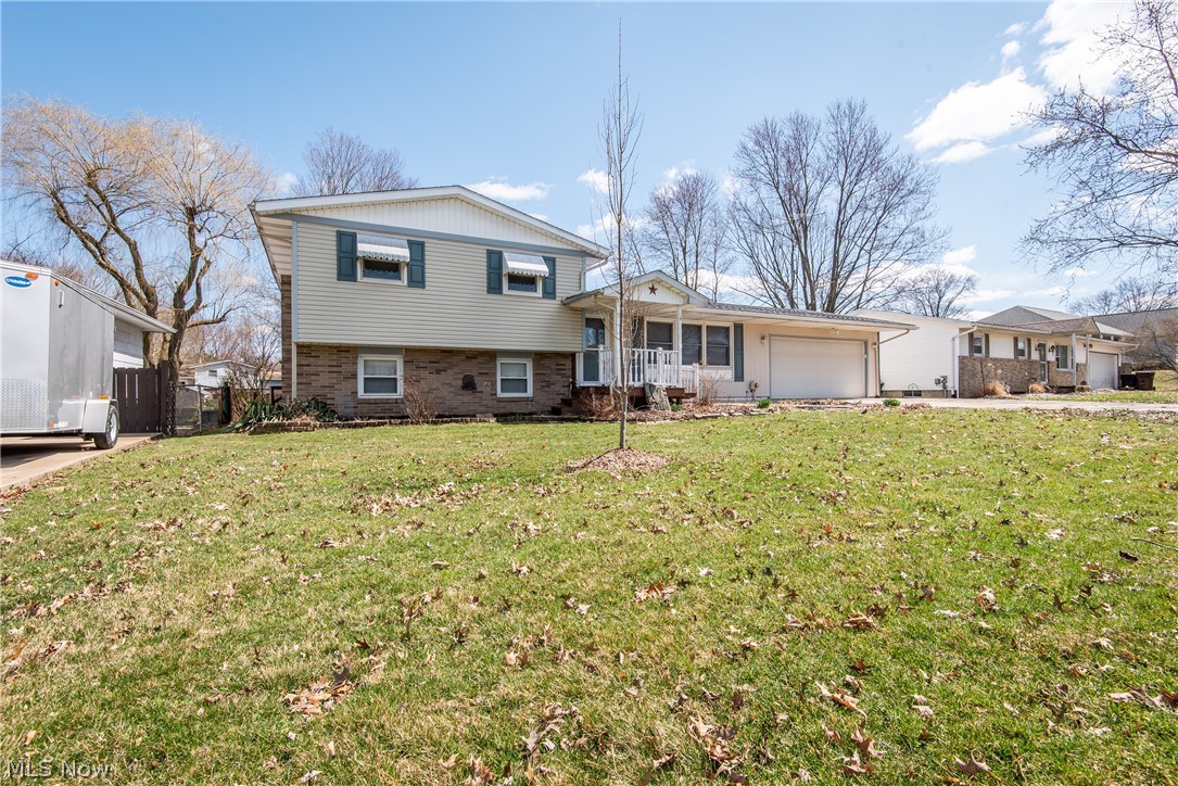 COME TAKE A LOOK at this 4 level split in Perry Township.  This 3 bedroom, 1.5 bath home has a lot of features to love.   Original hardwood flooring in many of the living areas make a nice statement.  The kitchen has received numerous updates including cabinets, countertops, sink and appliances.  The wall from the kitchen to the dining area was removed to allow for large dinette.   Off the dining area, there are sliding doors to the 3 season sun room.  On the 2nd floor, you will find 3 bedrooms all with hardwood flooring and a full bath with tile flooring and decorative tile backsplash.  The lower level offers additional living and entertaining space with a family room, half bath, and an extra space which might make a great home office.  The best part of a 4 level split is you have all this living area plus plenty of room for storage in the unfinished basement.  Outside, enjoy the fully fenced yard, fire pit, area for your grill and patio set, plus multiple outbuildings for increased s