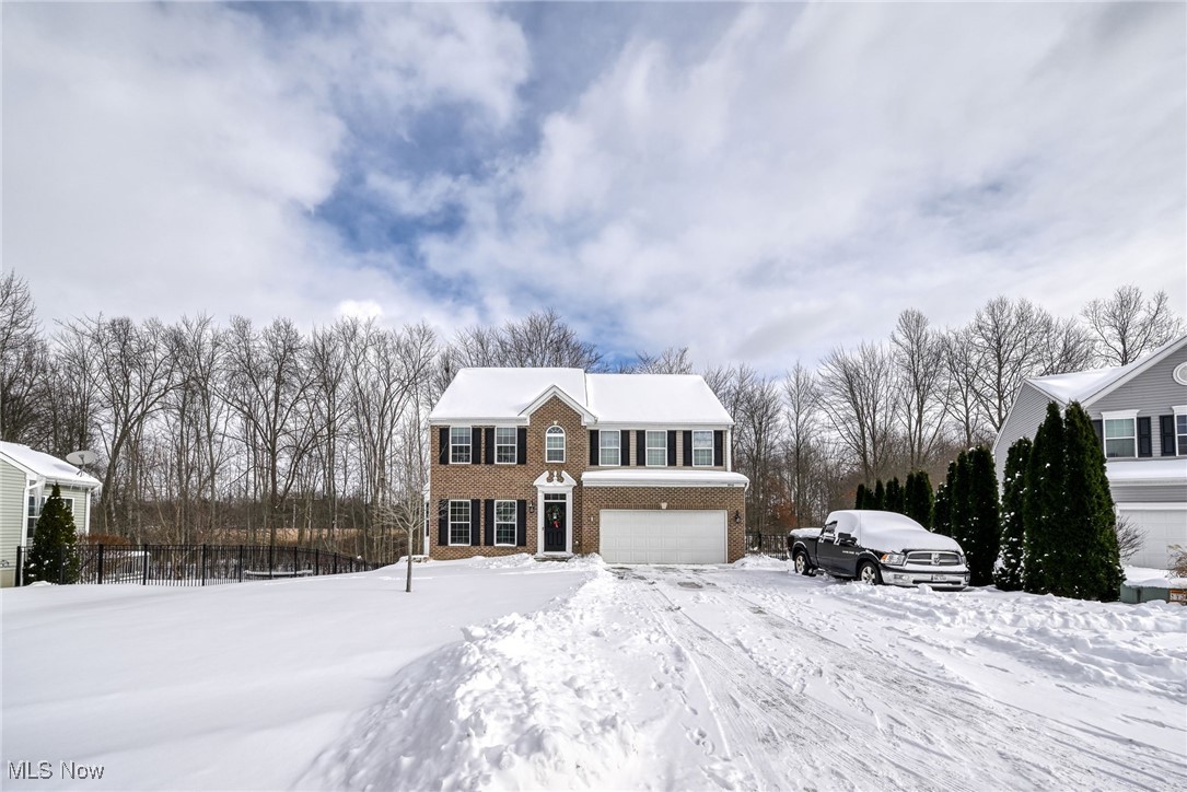 Welcome home to this stunning, light-filled beauty showcasing a calm, neutral color palette that creates a warm and inviting atmosphere throughout. The brick front and updated shutters give this home a beautiful stately grand appearance upon arrival. Immediately on entering you are greeted with a gorgeous view from entry straight through to the massive wall of windows to the back of home. Graceful columns define the entry and formal dining. The two-story vaulted family room features a dramatic floor-to-ceiling stone fireplace and a breathtaking wall of windows that fills the home with natural light and gives you a beautiful backdrop of nature. The heart of the home is the granite-countertop kitchen with a large center island, plenty of cupboards and work space -- perfect for everyday living and entertaining. Enjoy your morning coffee in the serene morning room, host memorable gatherings in the formal dining room and work comfortably from the private home office. The back of the home features a wonderful multi-level deck, allowing ease of enjoyment and relaxation outdoors! The primary suite is a true retreat, offering a double vanity, separate soaker tub and shower with seating, and a walk-in closet. The first floor has been updated with LTV plank flooring and the guest half bath updates feature stylish, modern finishes. The lower level has been finished with a full bath, bar and a family room with french doors leading outside to a wonderful patio and fenced rear yard. The fenced yard, double-tier deck and patio are truly the perfect space to relax, play or entertain. The concrete driveway is extra wide, allowing additional parking off to the side of the garage. This home has so many upgrades and extras already done throughout, offering comfort, style, and functionality-an absolute must-see for this price point in all it has to offer!