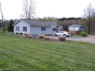This home sits on 6 acres of land with a small pond. The home offers 3 bedrooms and an open floor plan. The living room has a sliding patio door to a backyard patio and a backyard fire pit. The kitchen comes with appliances. The utility room is set up for your washer and dryer. A 48’ x 32’ pole barn with oversized doors is perfect for all of your hobbies and storage. This all-electric house has 6” walls and is super insulated, the average cost is $137.00/mo (per Ohio Edison). Septic system is under an inspection contract with twice annual inspections, cost is $125.00/year. Special tax assessments: Stormwater District $18.44/year, Solid Waste (recycling) $33.83/year. This property is convent to 3 major highways, a public library, restaurants, healthcare facilities, hiking/biking trails, parks, and conservation areas.