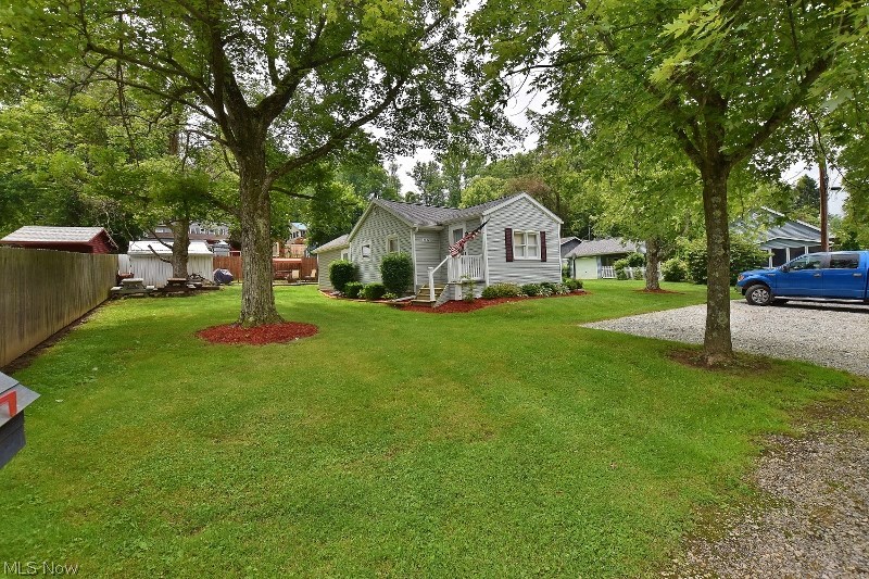 Completely updated turn key vacation cottage at Atwood Lake on 2 private lots (NO LEASE) in the Sunset Valley community. The cottage has been completely updated and ready for your enjoyment. 2 dock slips are located just a short walk away and a 24' pontoon boat and motor can be purchased separately if desired. You will love the spacious covered patio with ceiling fans to enjoy the great outdoors at Atwood Lake. A new forced air natural gas furnace along with central air conditioning is being installed  offering the new owners year round comfort and peace of mind. You will love the new knotty pine family room with 2 walls of windows and a gas fireplace. In addition is a living room (unfurnished) that has a second gas fireplace. A newly added utility room with exposed metal ceilings is charming and also serves as a mud room. So you can immediately enjoy your new lake home, the kitchen ware, bath and bed linens will also remain. Two sheds offer storage. The matching patio furniture under