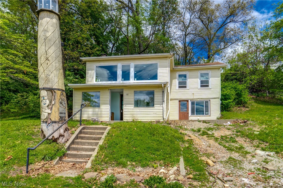 Portage Lakes View Investment Opportunity | 6 Parcels | Partially Rehabbed! Wake up to stunning lake views in this unique investment property situated on 6 parcels in a prime location. Whether you're looking to finish the flip, add a rental to your portfolio, or create a sought-after Airbnb retreat, this property offers incredible potential with a significant head start already done for you. The heavy lifting is complete — all major mechanicals are newer, including the furnace, air conditioning, plumbing, and electrical systems, as well as newer windows throughout. Drywall work has already been started on the main level, so you're ready to hit the ground running. The first floor features a welcoming enclosed porch, a living room with a fireplace, a kitchen area, and a utility room housing the furnace. The main-floor bedroom boasts beautiful lake views, a walk-in closet, access to a patio slab, and an en-suite bath with a single-stall shower — already framed and ready to finish. Head upstairs and you'll find the showstopper — a bright loft area surrounded by windows framing breathtaking views of the lake. Two additional bedrooms, including one with a large closet, share the upper level along with a hall bath featuring a tub/shower combo, a dedicated laundry room for stacked units, and a spacious en-suite bath plumbed for a double vanity with a large walk-in shower. Outside, enjoy the beauty of lakeside living with serene views and easy access to everything lake life has to offer. The property includes a small shed. Don't miss this fantastic opportunity; schedule your showing today!