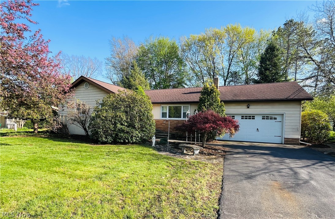 Welcome home to this versatile, raised ranch over a full basement. And, in the sought-after Squares Acres neighborhood of Madison Village. Charming and delightful, this 3 bed, 1.5 bath home is full of unique amenities that speak to it's customization and care. At the street the property greets you with it's strong Shagbark Hickory trees. Continuing throughout the grounds, you'll find well placed and complimentary horticulture selections; Japanese maple, Arborvitae, crab-apple, weeping cherry, hydrangeas, varieties of ivy, decorative grasses, holly, and more. Newer replacement windows throughout, storm doors, newer garage door and lift. Garden window for your herbs, offering great lighting into the heart of the home - and overlooking the backyard. Beautifully planned landscaping and mature conifers are a year-round anchor for this well-settled home and grounds. Paver patio and walkways create a comfortable, winding path around the home. Back inside, the oak floors thought the kitchen and bedrooms are original, bringing the quality and craftsmanship expected. In the full footprint basement, appreciated and useful space continues. Large laundry/ utility and storage room with a double concrete utility sink. The Rec room is a roomy and flexible area at 38'x12'. There is a canning or wine cellar area, as well as a craft room, office, or workshop. Close to the YMCA, schools, shopping, parks, wineries, golf, and the lakefront. Security system installed. Offered with a one-year home warranty included. Contact Ben for your private showing today.