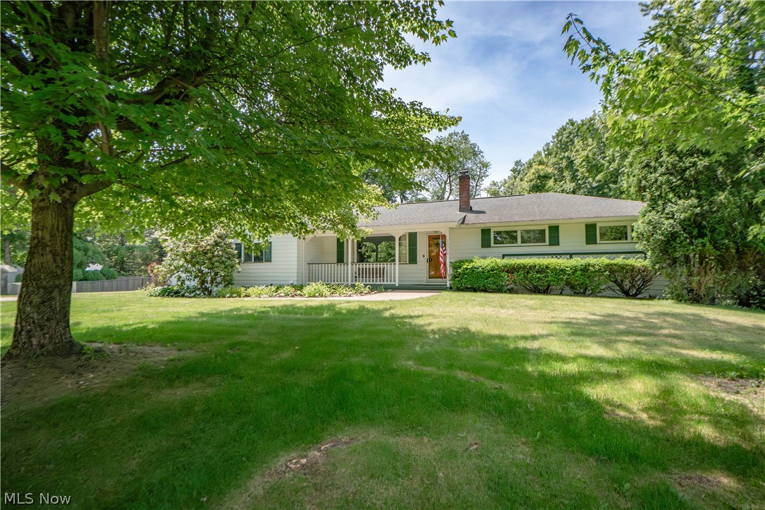 Welcome to this spacious ranch offering comfortable one-floor living with bonus finished space in the walk-out lower level. A covered front porch welcomes you inside to a bright living room filled with natural light from the large picture window, creating an inviting space to gather or unwind. From there, the home flows into the eat-in kitchen, where generous dining space, breakfast bar seating, stainless steel appliances, two wall ovens, an electric cooktop, pantry storage, and a large sink make everyday living and entertaining feel easy.

Just off the kitchen, the mudroom/bonus room adds even more functionality with updated flooring, a cozy gas fireplace, and direct access to the covered back deck. Down the main hallway, you’ll find four bedrooms and a full bathroom featuring a dual-sink vanity, tub/shower combination, and built-in storage.

The finished walk-out lower level expands the living space with a large recreation room featuring a propane fireplace, picture window into the sunroom, built-in bar, and built-in shelving. A workstation area, full bathroom with shower, laundry/utility space, and additional storage room provide plenty of room for hobbies, work, and everyday needs. The lower level also connects to a sunroom with recently replaced windows and a stone floor, offering a peaceful place to enjoy views of the backyard year-round.

Outside, enjoy a fenced backyard with mature trees, a covered deck, storage shed, and plenty of green space to relax, garden, play, or entertain. The attached two-car garage is heated and insulated, with additional driveway parking for convenience. With 4 bedrooms, 2 full baths, a finished lower level, and wonderful indoor-outdoor living spaces, this home offers more room and versatility than meets the eye.