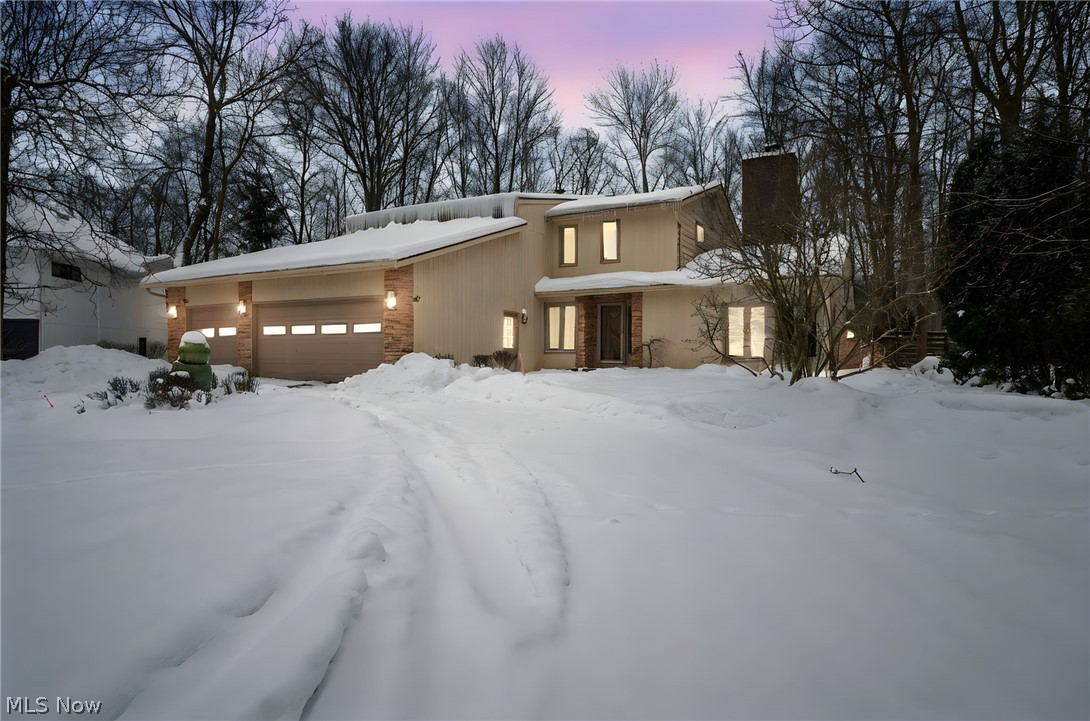 A striking mid-century residence quietly set at the end of a cul-de-sac in one of Orange Village’s most desirable locations. Privately positioned, this home offers a rare sense of seclusion while remaining effortlessly elegant—an architectural statement in a premier neighborhood setting. French doors open into a living room rich in character and warmth, where corner windows frame the outdoors and exposed wood beams draw the eye upward. Natural wood detailing, fireplace, and custom built-ins create a space that feels both curated and inviting. The dining area carries a clean, modern sensibility and flows seamlessly into a generous office or flex space, ideal for today’s lifestyle. At the center of the home, the chef’s kitchen blends form and function with ease, anchored by a statement island, cherry cabinetry, granite countertops, stainless steel appliances, a wall oven, and sculptural modern lighting. The breakfast nook opens directly to the patio, blurring the line between indoor comfort and outdoor living. The family room features a dramatic stepped ceiling with exposed wood beams that add architectural depth and timeless appeal. With direct access to the patio and expansive backyard, the space is perfectly positioned for entertaining or quiet evenings overlooking the serene grounds. Upstairs, four bedrooms offer comfort and privacy. The primary suite is a true retreat, complete with a spa-inspired ensuite featuring a jetted soaking tub, crystal-door shower, dual back-to-back vanities, and a walk-in closet. Two additional bedrooms share a full bath, while a fourth enjoys its own private ensuite—ideal for guests or multigenerational living. The lower-level recreation space extends the home’s versatility, offering endless possibilities as a media lounge or game room, along with a convenient half bath. With its secluded setting and architectural depth, and new roof and windows installed in 2025, this residence offers a refined lifestyle rarely found.