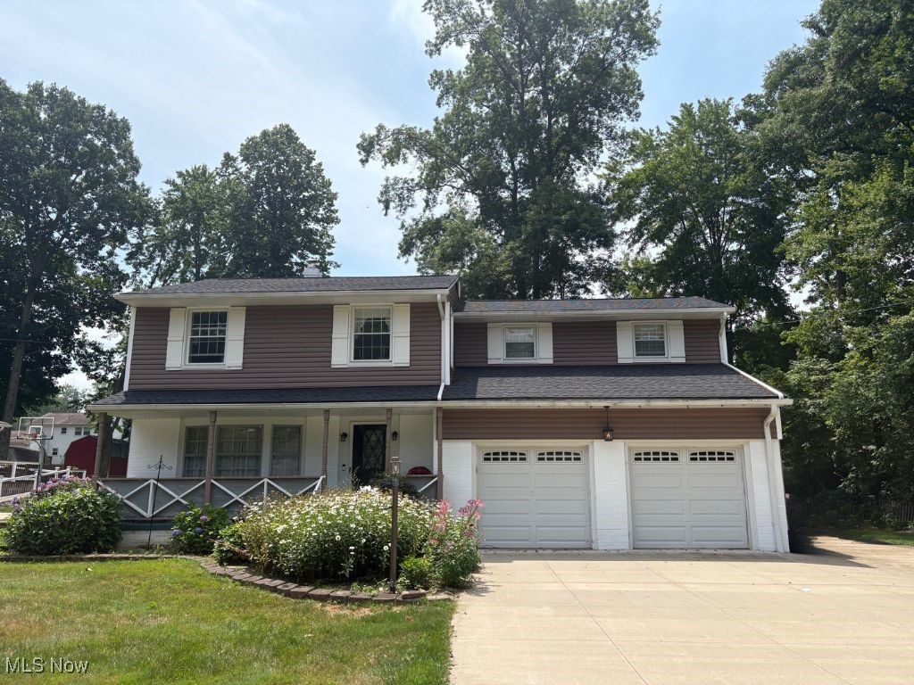 Don't miss this beautiful 4-bedroom, 2.5-bath colonial in a desirable Tallmadge neighborhood surrounded by mature trees and spacious lots. The first floor offers a formal living room, formal dining room, half bath and a cozy family room with wood-burning fireplace. There's also an updated kitchen featuring a double-sided pantry, dining space, and a charming pocket door. Natural wood flooring, built-ins, and abundant natural light enhance the main level. The real showstopper is the comfortable and large 4-seasons room which overlooks the backyard and new patio deck—perfect for relaxing or entertaining.

Upstairs, the rare butterfly staircase separates an enormous primary suite with ensuite bath from the additional three bedrooms and remodeled full bath, offering both privacy and functionality. All bedrooms are generously sized—two with natural wood floors and two with newer carpet. The basement provides excellent storage or recreation space, an additional refrigerator, and laundry area with washer and dryer.

Set on a 0.4-acre lot, this property includes a fenced area enclosing the patio deck, a playset, and a driveway with extra parking beside the two-car garage—ideal for additional vehicles, a boat, or an RV.

Updates include: Roof (2024), Main Sewer Line (2024), Hallway Full Bathroom Remodel (2024), Carpet (2024), Fence (2024), Patio/Deck (2024).  Other mechanicals: Furnace (2012), A/C (2019), Water Tank (2015).