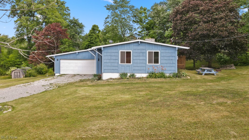 Country living in West Branch Schools.  4 bedrooms & 2 full baths.  Newer roof & windows.  Raised ranch with 2 car attached garage.  Kitchen, living, dining room and 3 bedrooms on main level.   Rec room with fireplace, 4th bedroom and 2nd full bath make up the lower level.  Large lot plus deck off of kitchen.  Small area in yard is fenced.