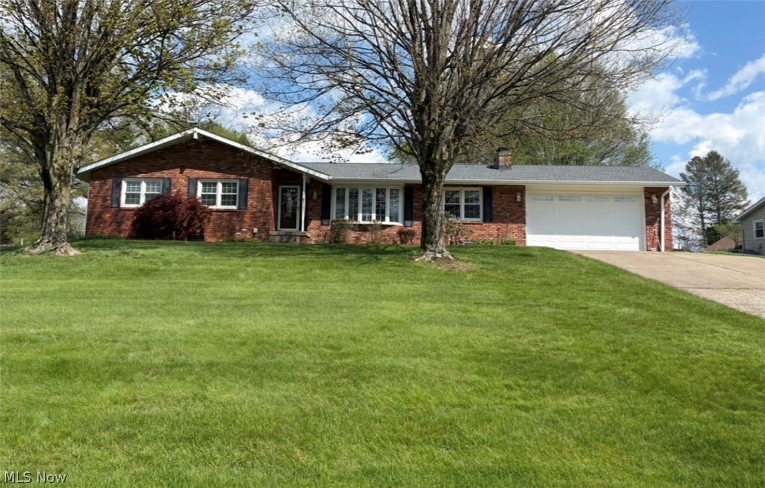 Hard to find well maintained brick ranch home with new roof on .93 acres outside city limits! You'll love this 3 bedroom, 2 bath home, big 2 car garage and huge detached 16X30 Amish shed with water, electric and garage door. The beautiful landscaped curb appeal draws you to it with newer windows and front door. Walk into the welcoming foyer just off the living room with lots of natural light from bowed window and includes a coat closet.  Dining room has beautiful Hickory Shutler cabinets with Corian counter and pullout drawers, nice corner closet and a walk out to the deck. Open eat in kitchen with Shutler Hickory cabinets pull out deep drawers, Corian countertop and backsplash, gas range, refrigerator, microwave and dishwasher. The bathrooms have Cherry Shutler cabinets. Family room with brick wood-burning fireplace, gas hook up. The lower level has a carpeted finished 25x24 finished rec room with a brick fireplace with wood burner plus a large unfinished area for weights storage or play.  Laundry area with new washer, dryer and sink. For outside entertaining, there's a nice covered 16 x 36 deck with uncovered area for sun, with skylights and fan. Huge backyard! This home definitely deserves a tour so book your private showing today! Home Warranty.