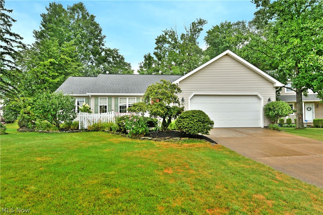 Quiet, serene and tucked away deep within a highly desirable local development, this lovely ranch style home is brimming with that downhome, comfortable feeling that eases your stress from the moment you step inside. Branching from an internal neighborhood cul-de-sac, a cement driveway extends towards the two-car attached garage. Lush landscaping veils a fenced-in frontal courtyard with its tendered mulch beds. Meanwhile around the back, offset staircases tie in a relaxing patio space with the must-see rear sunroom, a perfect place to take in the views. Inside, an open central layout finds tall, vaulted ceilings that rise above the crackling fireplace. Lush carpets run underfoot, continuing into the nearby formal dining room. The robust kitchen divides both the dining space an a welcoming family room as it presents its warm wood cabinetry, bold red countertops and bright white appliances found within the galley layout. Sliding doors open to the rear sunroom, introducing plenty of natural light. First floor laundry awaits nearby close to the garage entrance. Around the corner, find the inviting master bedroom, offering both its own private patio entrance, a walk-in closet and a full private bath. Two additional guest bedrooms bring the total to three as they join a colorfully appointed full bath of their own. Downstairs, a finished basement allows for easy rec space, entertaining and more as hidden storage and utility provisions include additional storage space.