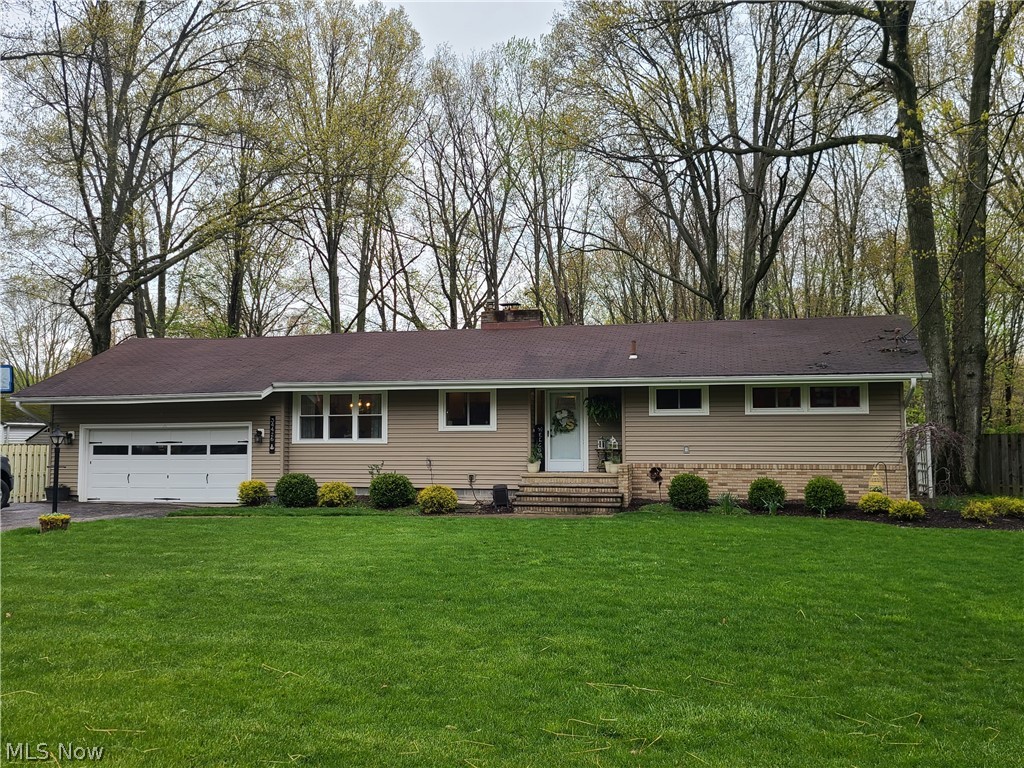 Fantastic  opportunity for one floor living on an offset secluded street in Avon, Ohio. This 3 bedroom 2 bathroom ranch has been passionately remodeled and is ready for new owners. Enjoy almost half an acre that backs to a serene wooded view, from a concrete patio perfect for entertaining. Close to I-90 and just outside the heart of Avon, close proximity to Avon Commons. Home improvements: NEW septic tank(2020), all new flooring throughout, updated full and half bath. The Great Room has plenty of natural lighting with a cozy gas fireplace. The kitchen has newer appliances, new countertops, new cabinets, and updated lighting and electrical. The exterior of this home has new siding and new gutters, and a new back slider door. The sellers are also adding a one year limited home warranty for peace of mind.
