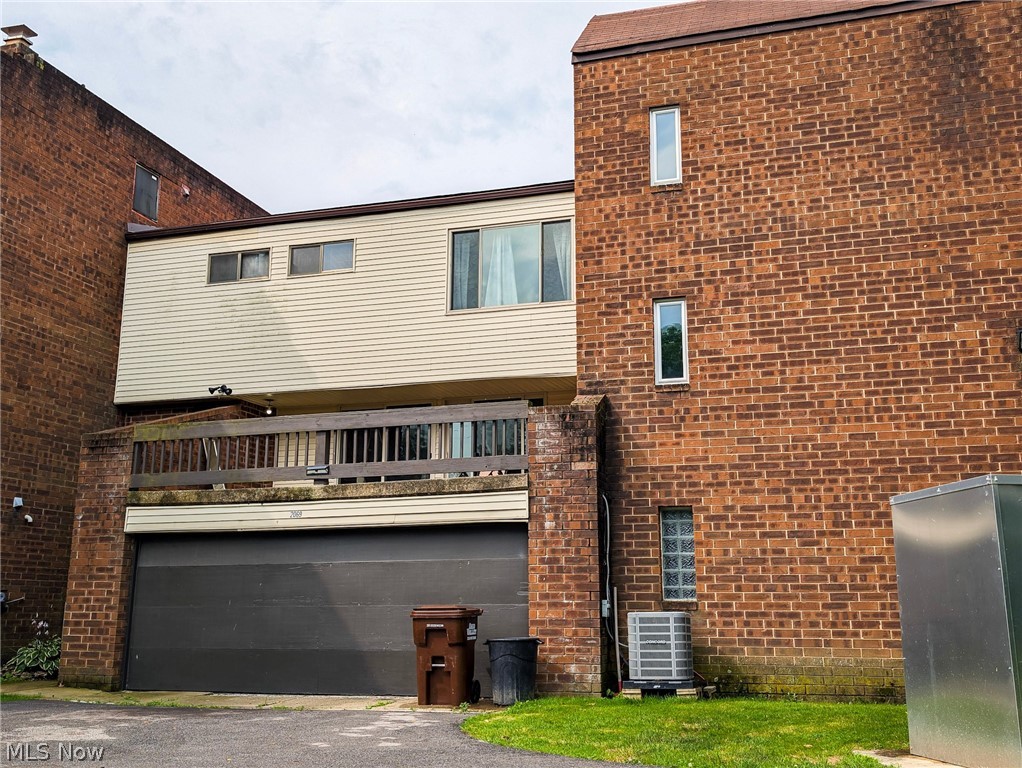 Don't miss out on your opportunity to experience the pride of homeownership for less than rent. This 2 bedroom, 1 1/2 bathroom condo is the perfect start. Sitting on one of the best lots in this complex, this condo offers private entertaining yard space, private and EXTRA parking. The location is prime, Coventry Schools, close to Summit County Metro parks and Top Golf. Direct entry off of your 2 car attached garage and into a finished lower level, complete with a private 1/2 bath, laundry room combination.  Up 1 level to the main living area/ Open and airy Living room, dining room and kitchen. Anchored by a classic and timeless exposed brick wall and 2 sliding doors with direct access to the very large concrete deck overlooking the park like back yard. So much inside/outside entertaining space. Up to the 3 level are the 2 nicely sized bedrooms and full bathroom. Both bedroom offer vaulted ceilings while the largest of the bedrooms also has the exposed brick wall. Main updates have been done, New air conditioner (2025) and New hot water tank (2025). This condo is ready for its new owners to put their finishing touches on it and realize the equity. Priced accordingly. Don't wait!
