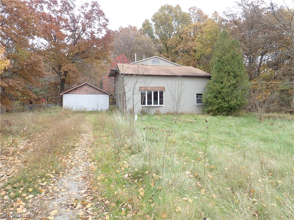 Large 2-story home featuring 3 bedrooms, 2 full baths, a fenced yard, large attic area for storage, additional room on 1st floor that could be converted to a 4th bedroom, office or playroom, .528 acre lot, vinyl siding, 2 car detached garage, close to Lake Milton.