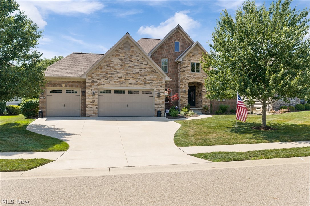Located in North Canton's highly sought-after Sanctuary community, this home offers access to exceptional neighborhood amenities, including a community clubhouse, pool, playground, sidewalks, and streetlights.  Enjoy the convenience of being just steps from the Stark Parks Trail, perfect for walking, running and biking. Gorgeous panoramic views of the lake from the house and outdoor retreat with 3 levels of paver stone patios. This 2772 Sq. ft. custom built home show evidence of quality craftsmanship and features 5 Bedrooms, 3 1/2 baths, first floor Master Suite and an amazing finished lower level with an additional 1336 sq. ft. with a pub style bar, Rec Room and ingress/egress windows. There are too many upgraded features to mention. Truly this one is better than new!