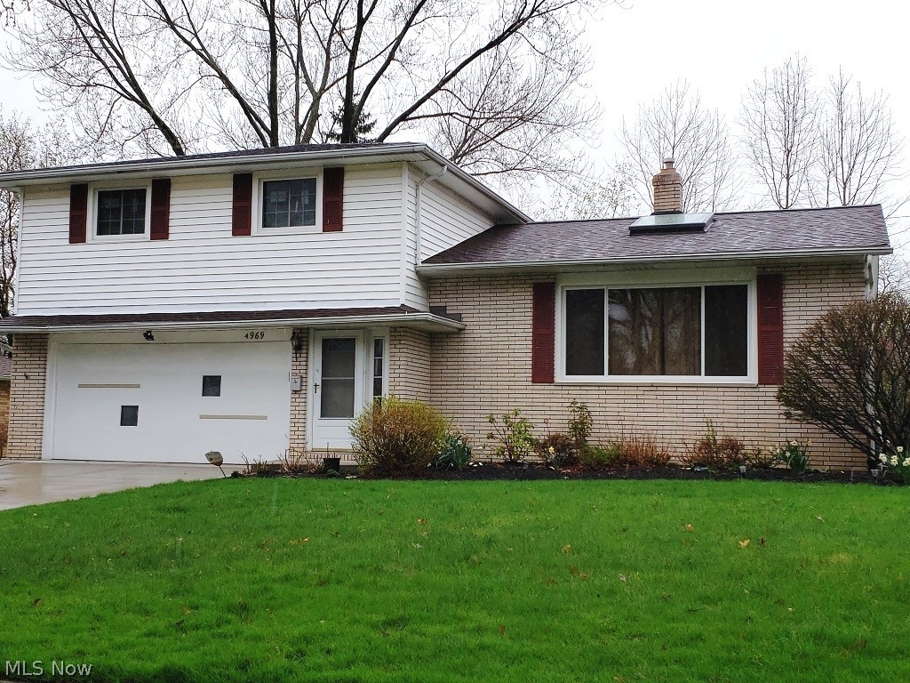 This wonderfully and recently updated light and bright 4-level split in prime location is a home that must be seen. Beginning in the spacious tiled foyer, the open and flowing floor plan is evident. It continues to the large living room with beautiful wood floor and new over-sized skylight and into the formal dining room with a corner built-in and brand new floor. From there the huge, fully applianced (most are newer stainless) eat-in kitchen with breakfast bar, brand new floor and planning area awaits. The comfortable fireplace family room with adjoining half bath and centrally located wet bar can be accessed from the foyer or the kitchen. A newer concrete patio overlooking the private tree lined yard is accessed from the family room. The upper level boasts 4 nice sized bedrooms including the master bedroom with its own private bath that has been updated with new tiled shower and floor. All 4 bedrooms feature gleaming hardwood floors. A full bath with tile floor completes this level.