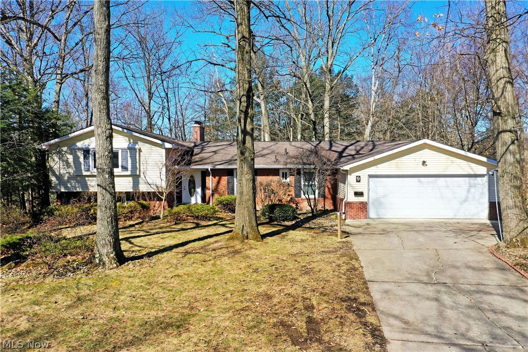 Initial looks can be deceiving, and this must-see Girard home is no exception to the rule! This massive, four level split is much more than meets the eye as it wows with a sprawling four-bedroom layout and a scenic placement overlooking a deep ravine with a burbling creek bed below. Tall trees surround the home as warm brick work accents the entryway and hidden, four car garage entrance: with its extra deep and extended cement footprint for easy multi-vehicle storage or additional shop space. A decorative entry door reveals the sun washed foyer while an equally illustrious central dining room branches away, opposite the main staircases. The remarkable rearward living room follows suit with its wood trimmed accent wall, brick trimmed fireplace and fantastic backyard views. Casual dining employs elegantly tiled flooring as it introduced the rear sunroom and adjacent rear patio to take in the naturescape all year round. Also included are a host of replacement tiles for both future upkeep and repair of the existing surface. Meanwhile, an impressively sized kitchen boasts plenty of counter space along with a corner half bath. Upstairs, a trio of bedrooms provide gracious footprints that increase in size to find the engaging master suite and its full private bath. A second full bath is found mid hall to complete the floor. Down at the lower level, a bonus bedroom joins a carpeted family room, perfect for entertaining. An additional half bath is paired with laundry services. The partially finished basement level is met with hidden storage to increase the allure.