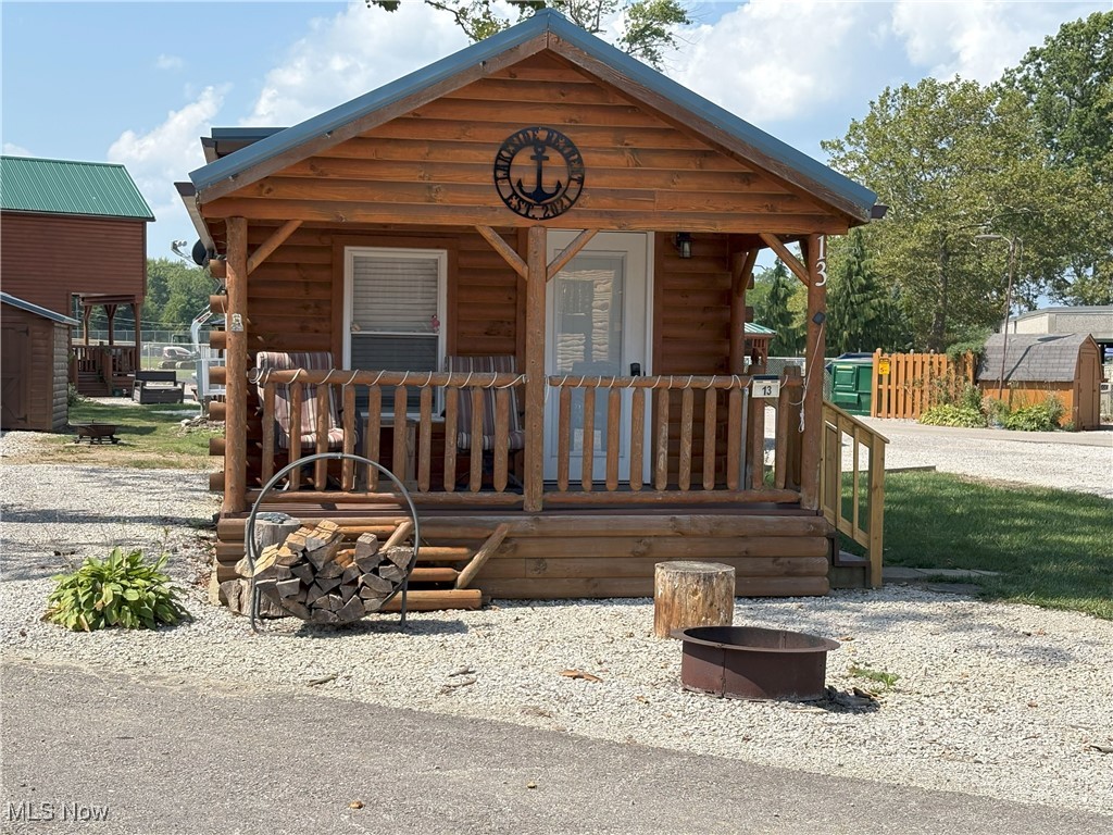 Wow, your own Retreat so close to the shores of Lake Erie.  This charming cabin is easy to maintain and will provide the relaxation you crave.  Enjoy the covered front porch or take advantage of those peaceful nights around your fire pit.
When you are ready for action this area offers an abundance of activities from the Strip at Geneva-on-The-Lake, to the scenic Lake Erie Coastal Trail.  Zip lining at the Geneva State Park, or tour the many Grand River Wineries. Plenty of shopping and restaurants located on historic Bridge Street in the Ashtabula Harbor. Fishing, bicycling, kayaking and hunting are all activities available nearby.  This ranch style cabin has an open floor plan with exposed beams and tons of charm.  Use as a vacation home or as an Airbnb.  If interested in using as an Airbnb rest assured current sellers already have an established client base. The Annual rental fee of $1,000.00 is paid for 2026. Now is the time to come and take a look and make this cabin yours!