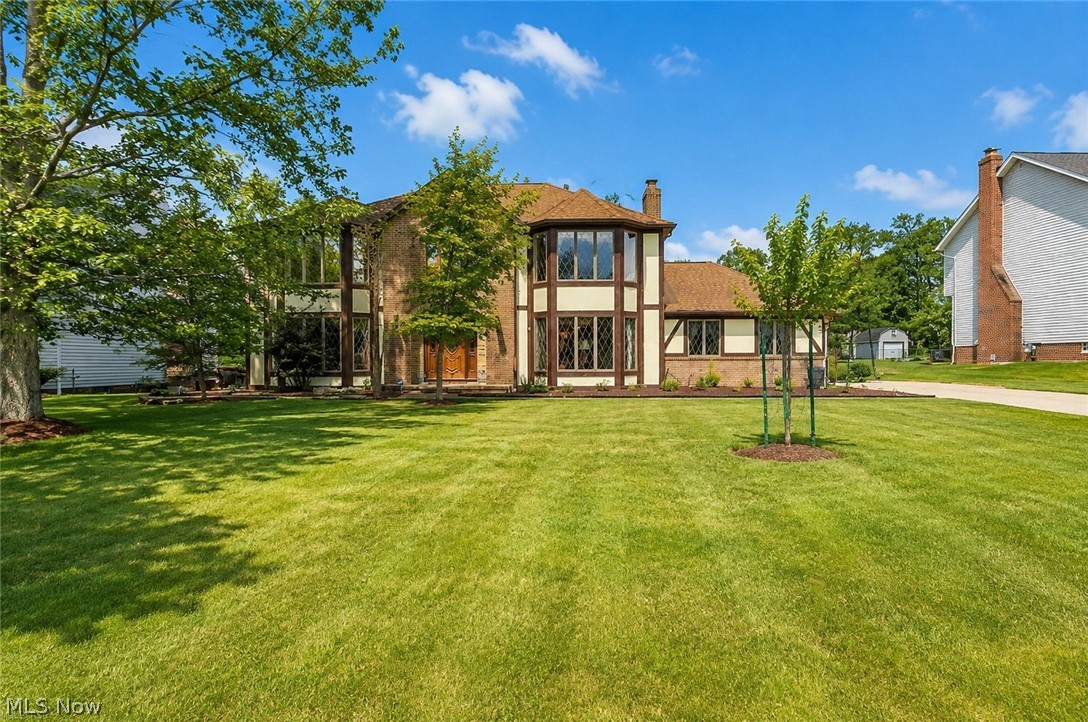 Classic Tudor-inspired charm and fantastic space await in this 4-bedroom, 2.5-bath colonial, situated on a generous 0.61-acre lot in North Royalton’s highly desirable Jamestown Estates. An eye-catching front facade framed by mature shade trees establishes immediate curb appeal, while large front windows bring plenty of natural light into the main living areas. The functional main floor offers a traditional layout, featuring an eat-in kitchen with solid granite countertops that opens up to the neighboring living and dining spaces and fireplace and first floor laundry. Upstairs, the primary suite serves as a spacious retreat complete with vaulted ceilings, a large walk-in closet, and a soaking jacuzzi tub alongside three additional bedrooms. Downstairs, the finished basement recreation room provides great bonus square footage for a playroom, home gym, or extra hangout space. The real highlight is the expansive backyard—step out onto the private rear deck to enjoy a huge, park-like lawn complete with your own producing apple and pear trees. Featuring an oversized attached garage with plenty of storage throughout, and quick access to top-rated schools, parks, and shopping, this one owner superior built solid home is move in ready. Set up a showing today!