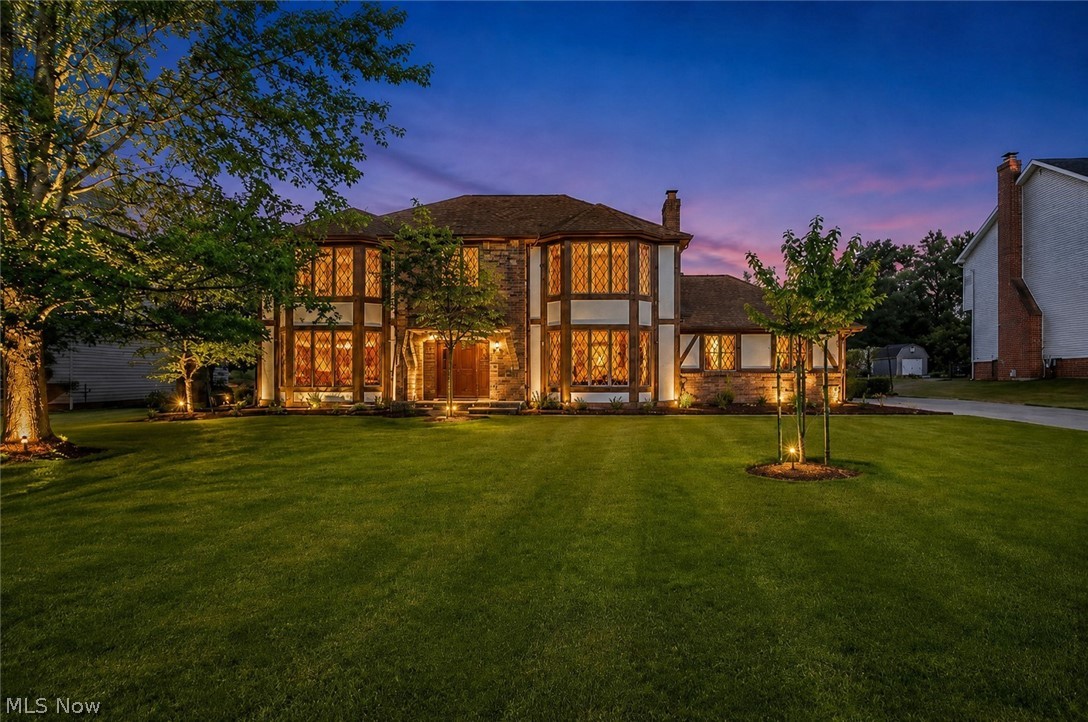 Classic Tudor-inspired charm and fantastic space await in this 4-bedroom, 2.5-bath colonial, situated on a generous 0.61-acre lot in North Royalton’s highly desirable Jamestown Estates. An eye-catching front facade framed by mature shade trees establishes immediate curb appeal, while large front windows bring plenty of natural light into the main living areas. The functional main floor offers a traditional layout, featuring an eat-in kitchen with solid granite countertops that opens up to the neighboring living and dining spaces and fireplace and first floor laundry. Upstairs, the primary suite serves as a spacious retreat complete with vaulted ceilings, a large walk-in closet, and a soaking jacuzzi tub alongside three additional bedrooms. Downstairs, the finished basement recreation room provides great bonus square footage for a playroom, home gym, or extra hangout space. The real highlight is the expansive backyard—step out onto the private rear deck to enjoy a huge, park-like lawn complete with your own producing apple and pear trees. Featuring an oversized attached garage with plenty of storage throughout, and quick access to top-rated schools, parks, and shopping, this one owner superior built solid home is move in ready. Set up a showing today!