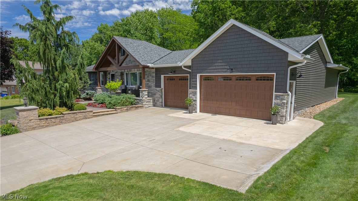 Welcome to 7742 Windy Hill Drive, where comfort, functionality, and quality craftsmanship come together. This beautifully maintained 3-bedroom, 3-bathroom home features an open-concept floor plan designed for modern living and entertaining.
The remodeled kitchen serves as the heart of the home, showcasing granite countertops, a stunning stone backsplash, and stainless steel appliances installed in 2019. Thoughtful updates and finishes create a space that is both stylish and functional, flowing seamlessly into the spacious living area. Gather around the impressive stone-wrapped fireplace, creating a warm and inviting focal point for family and guests alike.
The owner's suite offers a private retreat complete with a master bathroom featuring a walk-in shower. Two additional bathrooms provide convenience and flexibility for family and visitors.
Step outside to enjoy the beautifully landscaped yard and expansive back deck, complete with a covered bar area and TV hookup—perfect for entertaining, hosting game days, or relaxing outdoors.
Car enthusiasts, hobbyists, and entrepreneurs will appreciate the exceptional 6-car garage featuring heated floors and a dedicated bathroom, offering year-round comfort and endless possibilities.
The home's exterior boasts attractive wood-look vinyl siding accented with stone finishes, delivering outstanding curb appeal and timeless character. Downstairs, the spacious unfinished basement provides abundant storage and serves as the perfect canvas to create additional living space, a recreation area, home gym, or whatever suits your lifestyle.
This one-of-a-kind property combines thoughtful updates, outstanding amenities, and exceptional indoor and outdoor living spaces. Don't miss your opportunity to make this remarkable home your own.