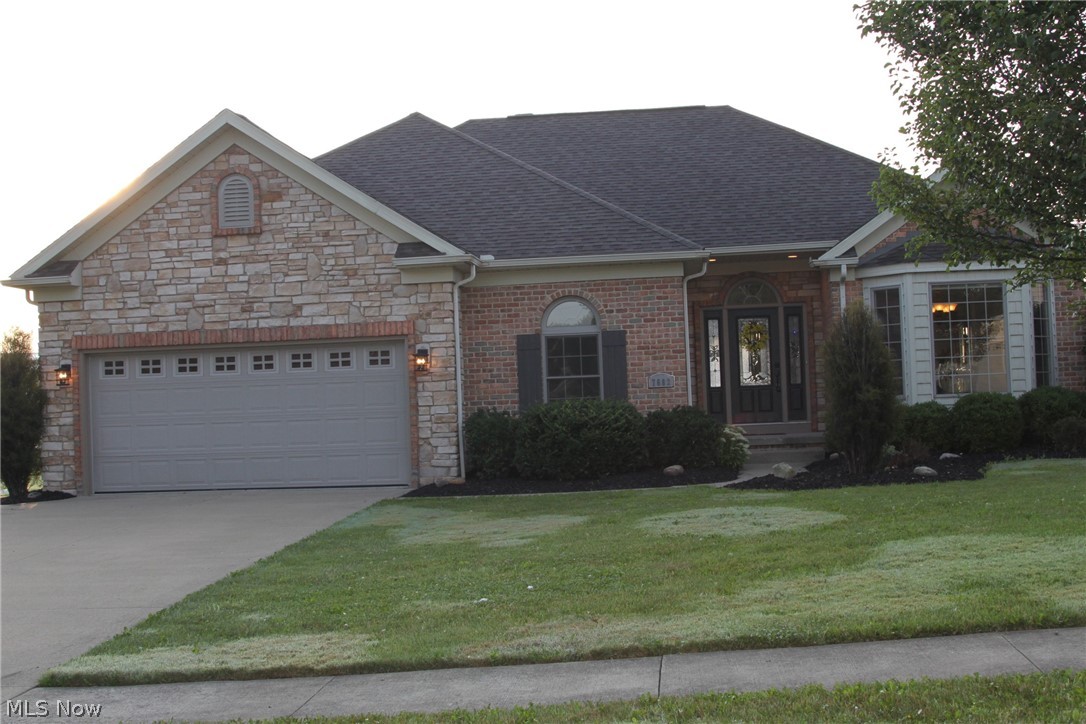 Brick & Stone accented, feature-packed ranch in Rolling Green with nearly 3600 in finished space is stunning from entry w/ beveled glass & sidelights entry door, wood entry floors, elevated ceilings w/ glass transoms, crown moulding, large & architectural windows, rounded drywall corners, metal spindles @ deck rail & stair rail, cathedral ceiling in great room w/ gas fireplace, designer eat-in kitchen w/ granite & solid surface counters, breakfast bar, tile floors & back splash, upgraded cabinetry w/ glass doors, accent lighting & crown. Full set of appliances including Jenn-air fridge & an eat-in area that exits to a large walk down deck.  Master bedroom features cathedral ceiling, large rear-facing windows & adjoining bath w/ separate vanities, jetted tub, walk-in shower, water closet & walk-in closet!  2 more generous-sized bedrooms, full bath, dining room, extra room & large laundry room round out the nearly 2300 sq ft main level. There is approximately 1300 finished square feet in