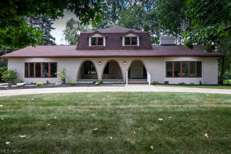 Mediterranean Style Design! The moment you walk into this home you'll enter into a spacious foyer with exposed staircase to second floor. Great room with cathedral beamed ceiling and large wood burning fireplace leading into a four seasons room with plenty of exterior view. Entertaining-size living room! Beautiful, formal dining room with gracious trim. Well groomed 2.5 bathrooms, first floor laundry room, master bedroom suite with private balcony. A huge 20' kitchen with center island and new stainless steel appliances. Wide lot with circular driveway and nice size finished garage. You must look at the  " NEW " improvements: high efficiency furnace, central air unit, hot water tank, floor coverings, painting, fixtures and more. Extra Nice-Extra clean and located in a neighborhood of high end value homes!