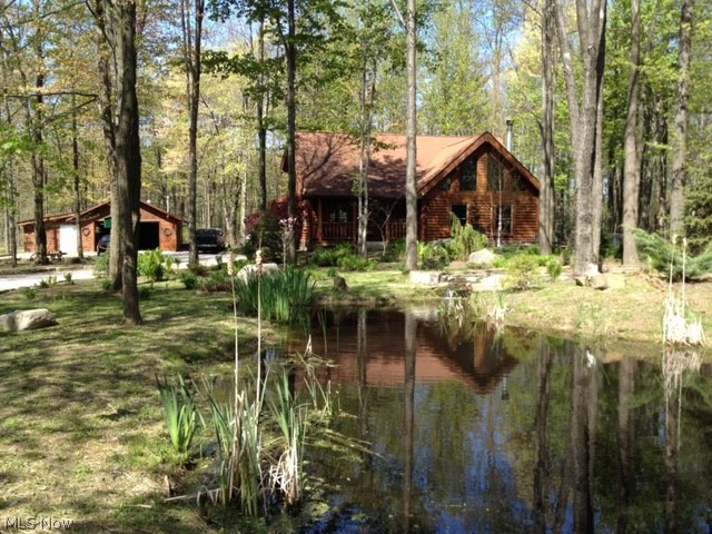 Fantastic Cedar Log Home!!This home is nestled on a wooded 3+ acre property in a park like setting. Post and beam construction with planked wood ceilings and floors.Dramatic vaulted great room with stone fireplace. First and second floor Master Bedrooms. Large 2nd floor loft can be used as a third bedroom  (currently used as a sitting room). Lower level Recreation area currently used as a third bedroom. Inviting front porch with stone walkway. Many updates to the home including new duct work. Decorative pond. Detached 3 car garage with 2 stalls and 2 rooms. City water is available at the street. 2019 updates include; new duct work; news radon system; septic inspection, cleaning and installation of new aerator; cabin and garage sealed and stained; new submersible sump pump. Come see this unique log home and make it yours.