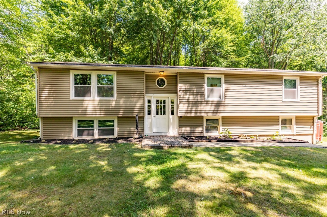 Move in ready bi-level on nearly 2 acres. This property offers lots of privacy on a beautiful wooded  lot.  Windows, roof, vinyl siding, insulation, gutters, doors, bathrooms all updated in 2015 -2016. New lighting throughout the home. New carpet in living room, and one of the bedroom. New kitchen countertop , dishwasher and updates to the floor plan done in 2017 -18.Section of backyard has been fenced in, and 16 x 10 shed added.  Basement rec room finished with new carpet and a built-in bar . Updated laundry room to include half bath. New Well pump, pressure tank and new water heater installed in 2022.