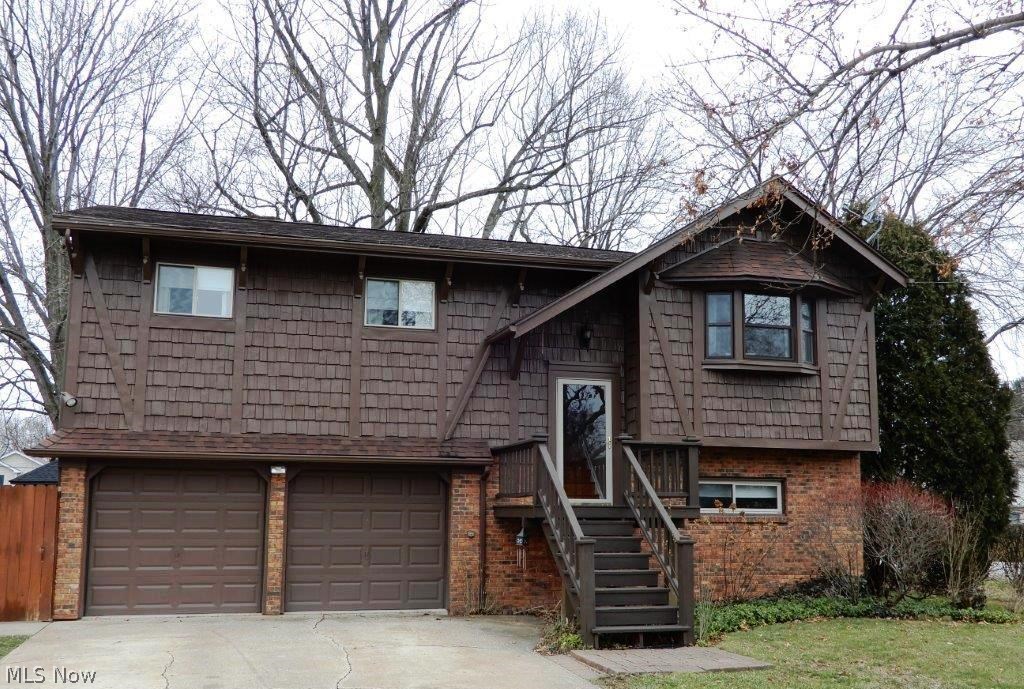 First time offered!  You will absolutely fall in love with this custom-built 4 bedroom/2 full bath one owner home.  Great curb appeal, and the pride of ownership is evident from the time you walk in the front door. Not your traditional bi-level floor plan, the main living area features a bright and cheerful eat-in kitchen with recessed ceiling and huge skylight! The formal living and dining rooms have a beautiful vaulted ceiling, and neutral decor.  There are even stairs in the back that lead down to the family/recreation room - very unique and functional! The main floor is completed with a large full bathroom, ample master bedroom, and 2 additional bedrooms.  The kitchen, bathroom, and all bedrooms on the main level have real hardwood flooring!  Venture downstairs and you will find an awesome family/rec room w/wood burning stone fireplace (back stairway up to the kitchen), full bathroom, a true 4th bedroom, and laundry room!  Attached 2 car garage w/workshop area, and two doors that l