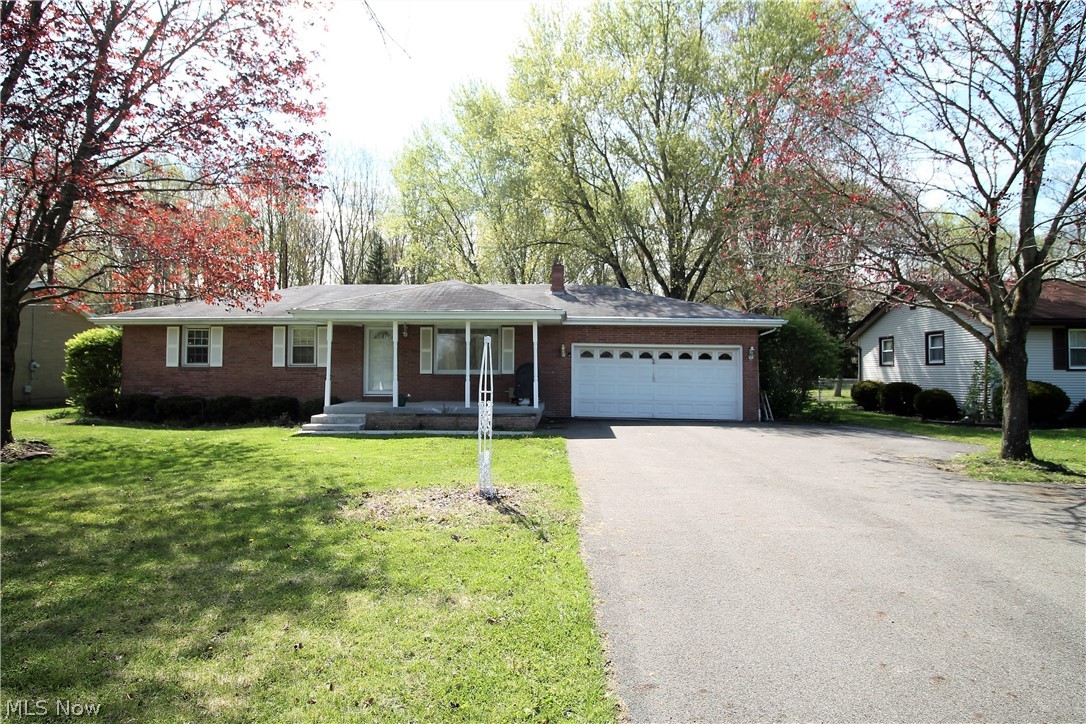 Welcome home to this charming brick three bedroom, possible 4 bedroom, two full bath ranch home. Enter from the new front porch, and new concrete walk into the great room with wood floors through out the main level. The large bright eat in kitchen offers abundance of counter space and cabinets, stainless steel appliances, Insta Hot at the sink for that fabulous hot cup of tea etc, work area, and large eat in dining area. Plenty of windows to let the natural light shine through. There is a remodeled full bathroom and three bedrooms on the main level. The lower level is partially finished and has new ceiling tiles with the finished area currently being used as a fourth bedroom. There is a full totally rebuilt bathroom with new shower door and shower seat stays with home and supports 350lbs, laundry room, tankless HWT, plenty of room for entertaining etc. The large backyard offers so much room for just enjoying or entertaining and there is a large shed and three car outbuilding.  Two car
