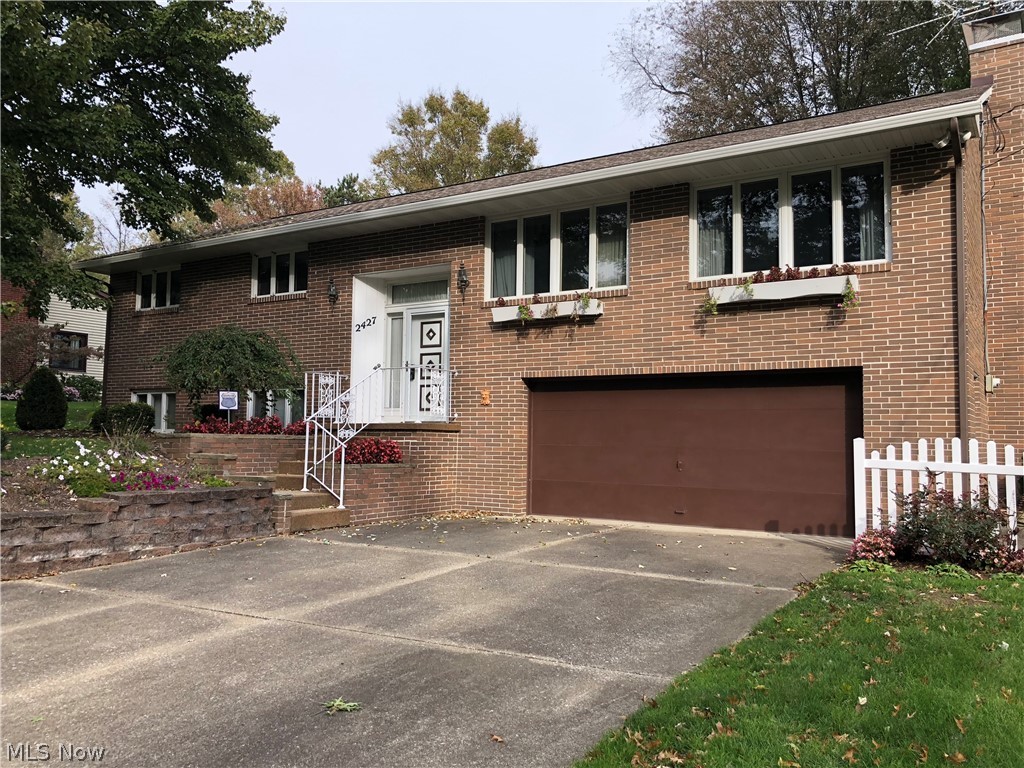 Welcome home to this beautiful brick house that features solid craftsmanship and quality construction. This bi-level, three-bedroom home has a spacious family room with a large brick fireplace, and a lovely enclosed back patio that looks over the back yard. The kitchen features wood cabinetry and is adjacent to a dining area; the living room has a large window and a ceiling fan. Ample storage and closet space on the main level and in each of the three bedrooms. There are two full bathrooms on the main level. The lower level has a large recreation room that would be a spacious playroom, craft space, home gym, or office. The lower level also contains a half bath and a lot of storage space. The furnace is brand new. The two-and-a-half car garage has built-in storage, including a work bench, and would be a great space for an auto enthusiast or someone who likes to build and tinker. The home has Nature Stone front steps and patio leading to the entryway. There is a storage shed at the back