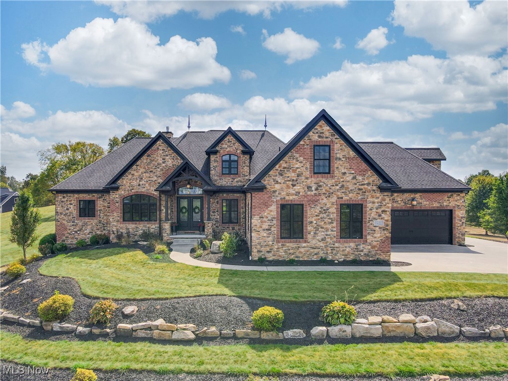 Welcome to this stunning Hartville home located in the highly sought-after Lake Local School District! Offering 6 spacious bedrooms, this property combines elegance, comfort, and functionality. The heart of the home is a beautiful eat-in kitchen with massive island, custom walk-in pantry and incredible views, perfect for everyday living and entertaining. A huge great room with a cozy fireplace serves as the centerpiece for gatherings and relaxation. Luxurious details such as 12 foot and coffered ceilings, crown molding and premium appliances elevate the charm and character throughout.  The huge master suite features soaring ceilings, direct access to the covered porch with a built-in fireplace, glamor bath with in-suite washer and dryer and 3 (three!) walk-in closets including a one-of a kind, speak-easy style custom closet & dressing room that you have to see to believe.
 
Convenience and thoughtfulness is maximized with laundry facilities on each floor, EV charging, and an invisible pet fence.

The walk-out basement with kitchenette, bar and movie room provides an amazing living and entertaining space, while the backyard is a true retreat featuring a sparkling pool with a brand-new liner and equipment, surrounded by a pristine yard ideal for gatherings and relaxation. A four-car, heated garage with direct access to the basement offers ample storage and convenience.