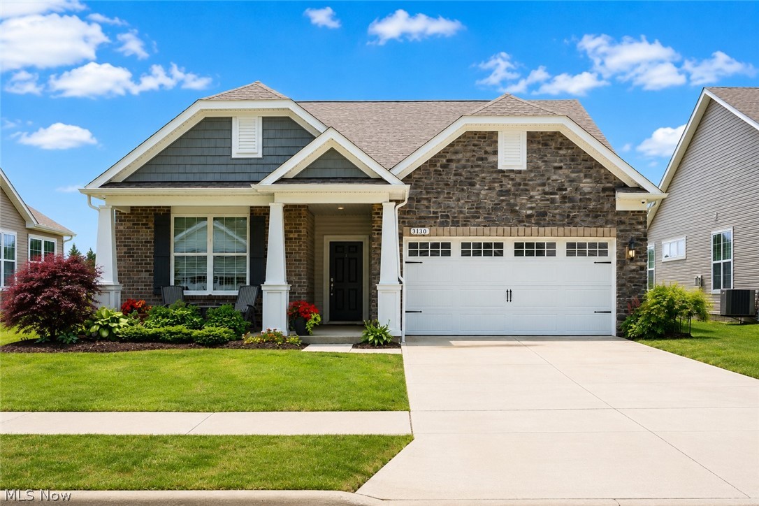 Welcome to easy, elegant living in this nearly new ranch home, perfectly positioned on a premium pond-view lot in Twinsburg Township's most desirable low-maintenance community. Built in 2022, this beautifully appointed home offers over 2,100 square feet of thoughtfully designed living space with an open-concept floor plan ideal for both everyday living and entertaining.
The spacious great room flows seamlessly into a stunning kitchen featuring an oversized granite island, abundant cabinetry, stainless steel appliances, a walk-in pantry, and generous dining space, all filled with natural light and picturesque water views. Luxury vinyl plank flooring extends throughout the entire home, creating a cohesive, low-maintenance design.
The versatile flex room currently serves as a home office but could easily function as a third bedroom, den, or hobby space. The private owner's suite features dual vanities, a walk-in tiled shower, and an oversized walk-in closet. Additional highlights include a dedicated laundry room, custom built-in mudroom storage, integrated data wiring, exterior security cameras, and exceptionally spacious rooms throughout. The sunroom offers additional flexible living space with panoramic pond views and direct access to the back patio.
Step outside to enjoy the stamped concrete patio, pergola, and hot tub while taking in tranquil water views and spectacular sunsets. The covered front porch provides another inviting space to relax and connect with neighbors in this welcoming community featuring walking trails and a vibrant social atmosphere.
The extra-deep, 3-car tandem garage with a four-foot extension offers outstanding storage, workshop potential, or room for recreational equipment.
If you've been searching for the perfect blend of modern comfort, generous living space, scenic views, and effortless one-floor living, this exceptional home is not to be missed.