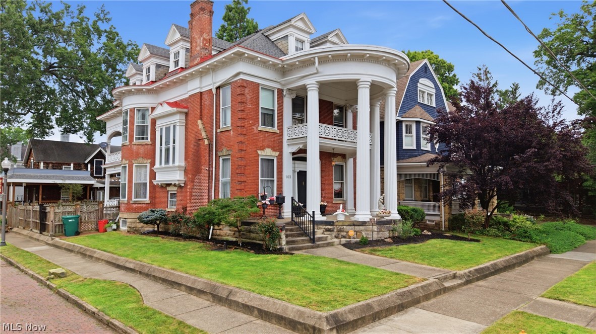 Homes don't come much more magnificent than this one, anywhere. The grand, imposing columns and leaded-glass entrance door announce why this is one of the most photographed homes in the Julia-Ann Square Historic District, and perhaps the state. The home captivates all who draw near, but the real magic begins when you step through the front door and find yourself dwarfed by the enormous foyer, complete with a Tiffany-style chandelier, fireplace, built-in benches, and a grand staircase welcoming you to the rest of the home. Which direction do you choose first? Through the beautifully crafted pocket doors into the receiving parlor? Or past the grand staircase to the splendidly unique oval dining room with built-in China cabinets, ornate cornice moldings, and an opulent fireplace? Either direction leads to even more to admire and discover. Keep exploring and you'll find a large formal living room and generous modern eat-in kitchen with a butler's pantry and radiant floor heat. Just outside, the professionally installed synthetic-turf backyard offers excellent drainage, low maintenance, and year-round enjoyment. Sneak up the back staircase to discover four large bedrooms, including a distinctive primary suite with an adjoining bedroom and nursery connected through the original shared bathroom. This stately 4,700-square-foot manor continues to surprise as you traverse the back stairs once again to the fully finished third floor, complete with a billiards room. Yes, a billiards room! The top floor also offers a modern full bathroom, two additional bedrooms, and an enormous cedar closet fit for a king and queen, or you. This impressive piece of early 20th-century architecture feels both grand and comfortable, with timeless touches such as an original claw-foot tub and marble sinks, along with three fully conditioned levels for year-round comfort. Come see this traditional mansion and prepare to be impressed.