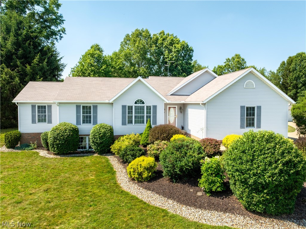 Tucked away on more than three picturesque acres in Lake Township, this custom-built ranch offers the perfect combination of privacy, quality craftsmanship, and everyday comfort. From the peaceful pond and mature landscape to the impressive 8-car garage capacity, this property provides the space and flexibility you've been searching for.  A welcoming foyer leads to a dedicated office with French doors, elegant crown molding, and abundant natural light, creating an ideal space for working from home. The spacious great room showcases soaring vaulted ceilings, a beautiful gas fireplace, and an open, inviting atmosphere that flows seamlessly into the kitchen. The kitchen offers custom cabinetry, newer stainless steel appliances, ceramic tile flooring, under-cabinet lighting, a stylish backsplash, and generous prep and storage space. Just beyond, the sunroom provides the perfect setting to relax and enjoy views of the surrounding property year-round. The private owner's suite is designed for relaxation, featuring a spacious ensuite bath with a jetted soaking tub, dual sinks, a walk-in shower, and direct access to the rear deck, where the hot tub creates a peaceful outdoor retreat. Two additional bedrooms and another full bath complete the main living area, while the conveniently located laundry room adds to the home's functional layout. Downstairs, the finished lower level offers a large recreation room, a full bathroom, and plenty of flexible space for movie nights, hobbies, a home gym, or guests. Outdoor living is just as impressive, with a spacious deck, paver patio, scenic pond, and expansive yard that invite you to relax and entertain. Car enthusiasts, hobbyists, and anyone needing extra storage will appreciate the attached two-car garage along with the detached  heated 6-car garage! Zoned agricultural, the property also offers endless opportunities for gardening, small livestock, or creating the hobby farm you've always envisioned.