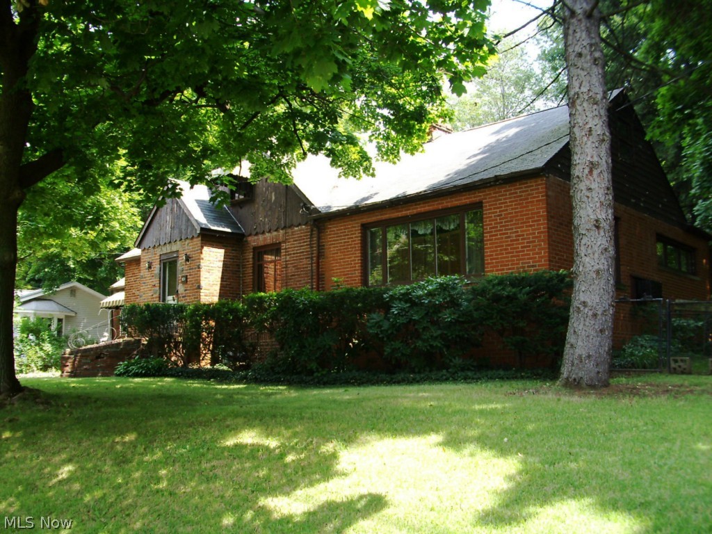 You haven't seen one like this one!  Needs work but will be a unique property when finished. Some large living areas, dining, family room, thanks to additions to the original structure. Walk up to knotty pine attic for storage. Currently a sewing room, 3rd bedroom possible with some floor plan changes.
Garage is approx. 24X24 and above is a massive loft for whatever hobby or storage needs you have. Access from the exterior stair case, worth the trip.
Roof was done in 2006, and the electrical service is being updated to 200 amp, plenty for both the house and the garage.
An extra lot is included which is behind the shady backyard.  Follow the footpath back to see it, there is an open grassy area and remnants of fence giving you an idea of the size 100X100 (approx. .23acre). Total of both lots is approx. .516 acre.