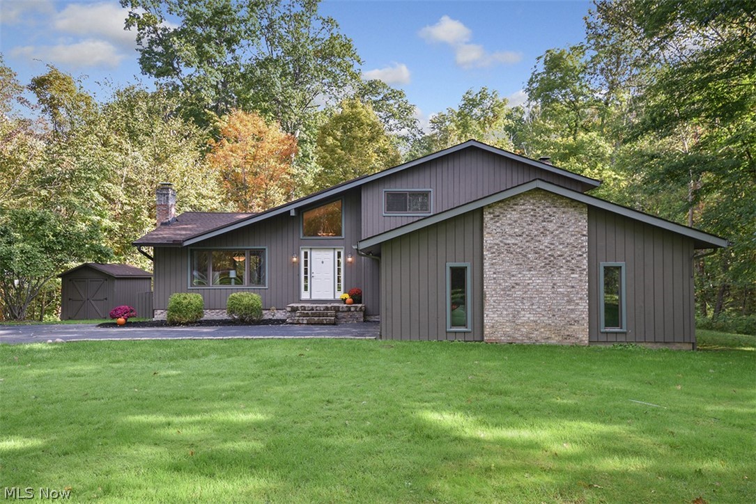 Wonderfully maintained and updated split on a picturesque 1.5 acres in Kenston Schools! Extensive renovations and updates throughout including designer fixtures and tasteful décor---welcome home to your everday retreat! Light and bright open concept living room and dining room boast a redesigned stacked stone fireplace and hand scraped African walnut flooring throughout. With over 1800 sqft of multi-tiered decking you're sure to have PLENTY of space to entertain both inside and out!  2 secondary bedrooms up share a renovated slate and granite appointed bath, and the master suite boasts a private deck overlooking the woods and a 2014 Restoration Hardware inspired, spa-like master bathroom. A spacious family room connects to what could be your 4th bedroom, den, playroom or office. The "down-to-the-studs" reconfigured kitchen renovation in 2012 includes custom cabinetry, granite, appliances and lighting, making this room truly the heart of the home. All new windows and doors in the whole