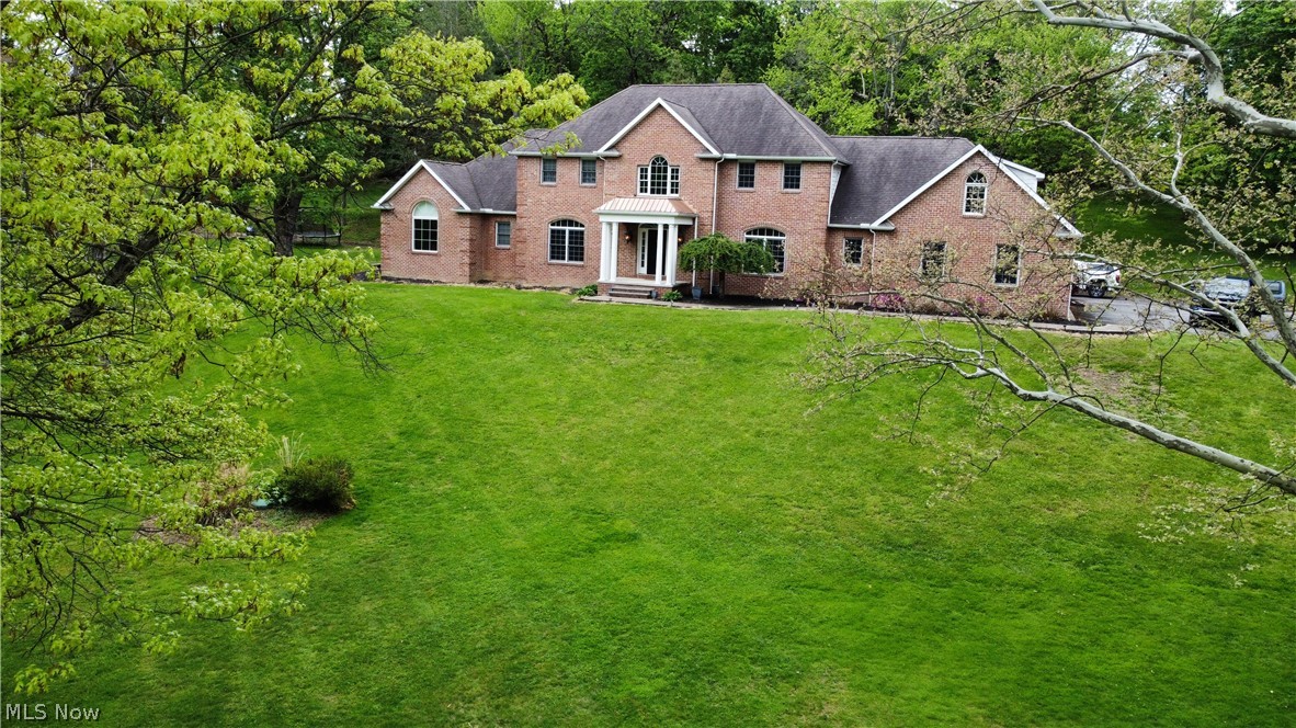 Situated on 2+ landscaped acres, this exceptional 7-bedroom, 4.5-bath residence offers luxury, comfort, and versatility throughout. From the moment you enter, you are welcomed by an open foyer highlighted by a curved staircase and timeless architectural elegance. Designed for both everyday living and entertaining, the spacious floor plan features a formal dining room ideal for hosting family and guests, along with a stunning living room centered around a floor-to-ceiling stone fireplace. The living area flows seamlessly into the kitchen, complete with spacious cabinetry, generous counter space, walk-in pantry, breakfast bar, and casual dining area. The impressive first-floor owner’s suite serves as a private retreat, featuring oversized walk-in closets and a spacious spa-style bath with a jetted tub, dual-head walk-in shower, and double vanity. The main level also includes a private office with French doors opening to the foyer and living room, an additional flex space, convenient laundry room, and a half bath.
Upstairs offers endless possibilities with secondary living areas and multiple bedrooms and optional office. Two bedrooms share a Jack-and-Jill bath with walk-in closet, vanity, and additional storage, while another bedroom features its own private bath. Additionally, you will find a separate bonus suite with a central living area, two additional bedrooms, and full bath.
Convenience continues with both stair and elevator access to all levels, including the expansive basement offering endless storage, recreation, or finishing potential. Outside, enjoy peaceful surroundings from the inviting front porch, multiple patios, and beautifully maintained flower and garden areas. Additional highlights include a storage shed, attached two-car garage, and paved driveway.
This truly remarkable property combines elegance, space, and functionality in a stunning setting you must see to fully appreciate.