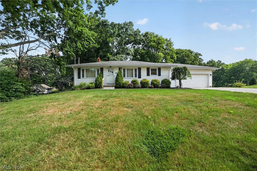 Desirous 3–4-bedroom ranch  with 1744 total square footage (1176 main level & 568 lower level)  including the lower-level recreation room (with closet) and an exterior door leading to  34 X 12 concrete patio. This home is situated on approx. .67 acres in City of Green   
The home features refinished original hardwood floors in living , dining , hall and 3 bedrooms. The open floor concept features living room and dining combined and open to the 2020 remodeled kitchen with breakfast bar, newer stainless-steel appliances, backsplash, ample countertop space for food preparation, upgraded electrical and lighting and ceramic floors. 
The primary bedroom is located in the NW corner, the middle bedroom has been utilized as an office with a sliding louvered glass door for access to the 24 X 13  freshly painted wood deck with stairs leading to rear yard.  The third first bedroom ( 12 X 10 ) also has attic access in the closet.  The bathroom was remodeled in 2022 featuring nice lighting, vent fan, tub and shower surround. 
Take a stroll down to the 2024 remodeled 40 X 13  recreation room  featuring carpeted floors, exit door to patio, closet and a sitting area near the stairway. This room could be utilized as a bedroom or recreation room for entertaining. The laundry located in lower level features a utility tub, electric dryer and washer. 
The furnace and electrical panel were replaced in 2009, a/c was serviced this year. The Point of Sale for well & septic have been completed with certificates in the supplements. A whole house ventilation system is located in the main hall.  There is an Old Republic Home Warranty included. There is a buried dog fence which just requires the transmitter to be reinstalled for application.   This home is truly ready to move in.