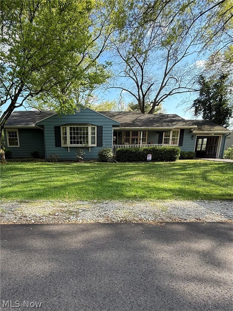 Welcome to this peaceful and serene home in the heart of Coshocton—offering the rare feeling of privacy while still enjoying the convenience of being in town. Step outside to a large, flat backyard perfect for relaxing or entertaining, complete with a patio ideal for gatherings. One of the home’s standout features is the beautiful four-season sunroom, where you can unwind year-round—cozy up with a heater in the winter to watch the snowfall, or enjoy the calming views of rain rolling in. The main floor offers three bedrooms, including a versatile space currently used as a closet that could easily serve as a nursery, home office, or additional bedroom—full of potential to suit your needs. The spacious living room features custom built-ins and a charming bay window that fills the space with natural light. Downstairs, the expansive basement provides even more living space, including a large family room area, an additional bedroom, a half bath, laundry area, and ample storage. This gorgeous home combines comfort, flexibility, and charm—truly a must-see!