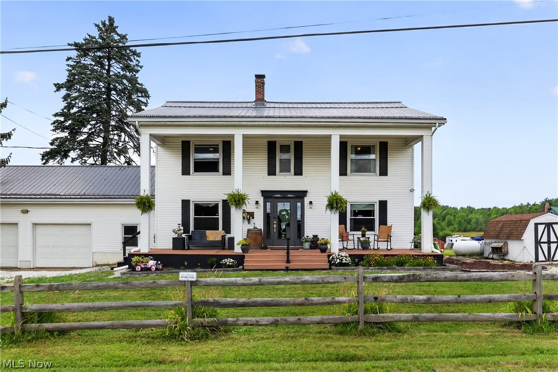 Some homes are simply lived in. This one has been loved. Built nearly two centuries ago in Newberry Township, this 3 bed, 2 bath colonial farmhouse on 2.2 acres has been thoughtfully and beautifully remodeled in the last five years. Every detail handcrafted with purpose, from the studs out to create a beautiful blend of old and new. Step onto the grand covered front porch, framed by black shutters and hanging ferns, and imagine sitting down with a cool glass of iced tea on a hot summer day. From there, you'll enter through a stately front door into a home that balances historic character with modern intention and farmhouse charm.
The kitchen features granite countertops, a deep double sink, brick-pattern tile flooring, and an extra-deep refrigerator, perfect for entertaining. Just off the kitchen, a custom built pantry adds even more everyday function.
Luxury vinyl flooring flows throughout the rest of the home, complemented by custom built-ins that add both beauty and function at every turn. The main floor bath features a stunning copper soaking tub, while the master suite offers a spa like micro-cement shower, a rare, designer level touch you won't find in most homes this age, or newer. A four seasons sunroom offers year round space to relax and take in the beautiful country views, no matter the weather.
A metal roof, windows and septic system (2018), hot water tank (2024), water filtration system (2026),propane heat, and a pellet stove round out some of the practical updates that let you enjoy the character without the worry.
Outside, 2.2 acres give you room to roam, a partially fenced yard, a chicken coop for the hobby farmer at heart, and space that's perfect for planting a garden or letting kids and pets run and play.
Located in the West Geauga school district, you're just minutes from Punderson State Park, with walking trails, camping, and a lake made for kayaking and lazy summer afternoons. This is a home with a story and now it's ready for yours.