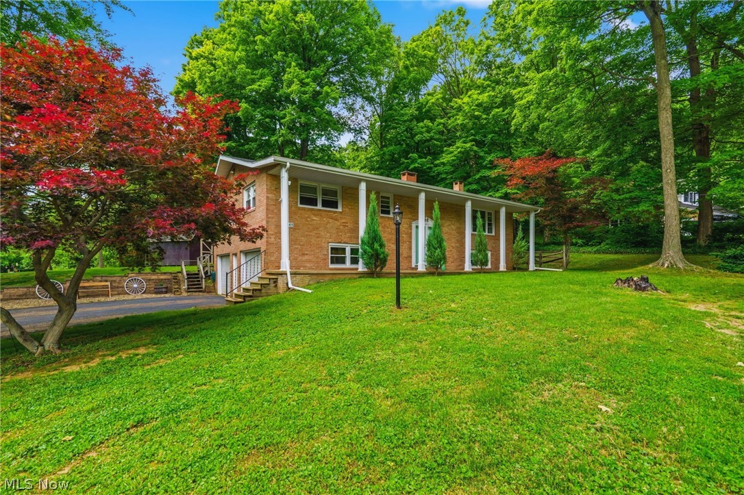 Welcome Home! Charm & Character with Peace & Tranquility.  Discover the perfect blend of thoughtful modern updates in this beautiful brick home in the perfect location. Built in 1968, this property has been meticulously maintained and upgraded to offer total comfort, efficiency, and peace of mind for its next owner. Spanning a spacious and highly functional floor plan, the home offers 2,100 total square feet of living space, thoughtfully divided into 1,100 square feet on the main level and a comfortable 700 finished square feet below. The Heart of the Home is stunning. Amish Kitchen, boasting premium Alpine Cabinets and beautiful Corian countertops, complete with a modern gas cooktop.  The inviting Living Room serves as the ultimate gathering space, featuring a magnificent see-through wood-burning fireplace equipped with a convenient gas start. The master bedroom includes convenient attic access and a uniquely practical closet outfitted with an outside light switch.  The bathroom has been refreshed with new lighting and a hidden safe. Nearby, a dedicated closet features ready-to-go hookups for a stackable washer and dryer.  Premium Upgrades & Improvements: No expense has been spared in upgrading the core components of this home. Beautiful Pella windows were installed in 2021, perfectly complementing the durable, stylish vinyl flooring added in 2022. Enjoy worry-free living with a roof and furnace both updated in 2018. The home features a fully updated 200-amp electrical service. A new water softener and iron treatment system were installed in the laundry area in 2021. Step through the new patio door onto a beautiful, textured stamped-concrete patio and matching sidewalks. The property also features a fenced yard and gutters equipped with leaf/gutter guards. This home is built to withstand the elements and keep you seamlessly connected: A whole-house generator ensures you are never left in the dark. Call today for a tour! This home is waiting for you!!
