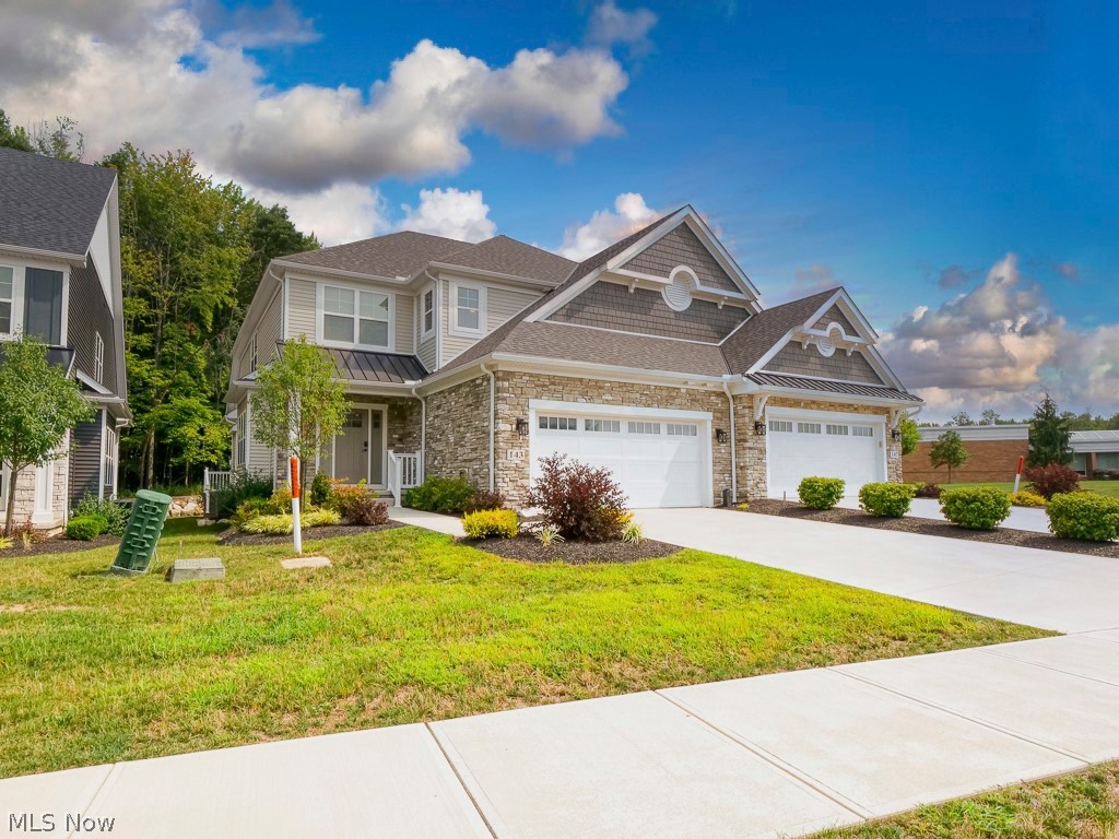 Former model home. Over $100,000 in upgrades. The largest floor plan in the community—and arguably its best lot.

The upgrades, layout, and setting separate this home from the rest. Built by Petros Homes and originally designed as the community's model, this 3-bedroom, 2.5-bath residence offers more than 2,500 square feet of beautifully finished living space, plus a full basement ready for your vision.

Step inside and the difference is immediate. Soaring ceilings, walls of windows, and an open-concept design fill the home with natural light. The showpiece kitchen features custom cabinetry, luxury stone countertops, high-end appliances, a designer range hood, oversized island with seating, and additional space ideal for a coffee bar or prep station.

The kitchen flows effortlessly into the dining and dramatic two-story great room, where a custom gas fireplace and expansive windows frame peaceful views of the wooded backdrop. Step outside to the private patio and enjoy a setting rarely found in townhome living—perfect for quiet mornings, summer dinners, or simply unwinding at the end of the day.

The first-floor primary suite makes true main-level living possible and includes private patio access, a spa-inspired bath with custom walk-in shower and double vanity, and an oversized walk-in closet. First-floor laundry adds even more everyday convenience.

Upstairs, two spacious bedrooms, a full bath, and a large loft provide flexible space for a home office, media room, playroom, or additional lounge. The full basement offers even more opportunity for future finished living space, storage, a home gym, or entertainment area.

With exterior maintenance, landscaping, and snow removal included through the association, you can spend less time maintaining your home and more time enjoying it. Conveniently located near shopping, dining, highways, and the highly regarded Brecksville-Broadview Heights schools.
