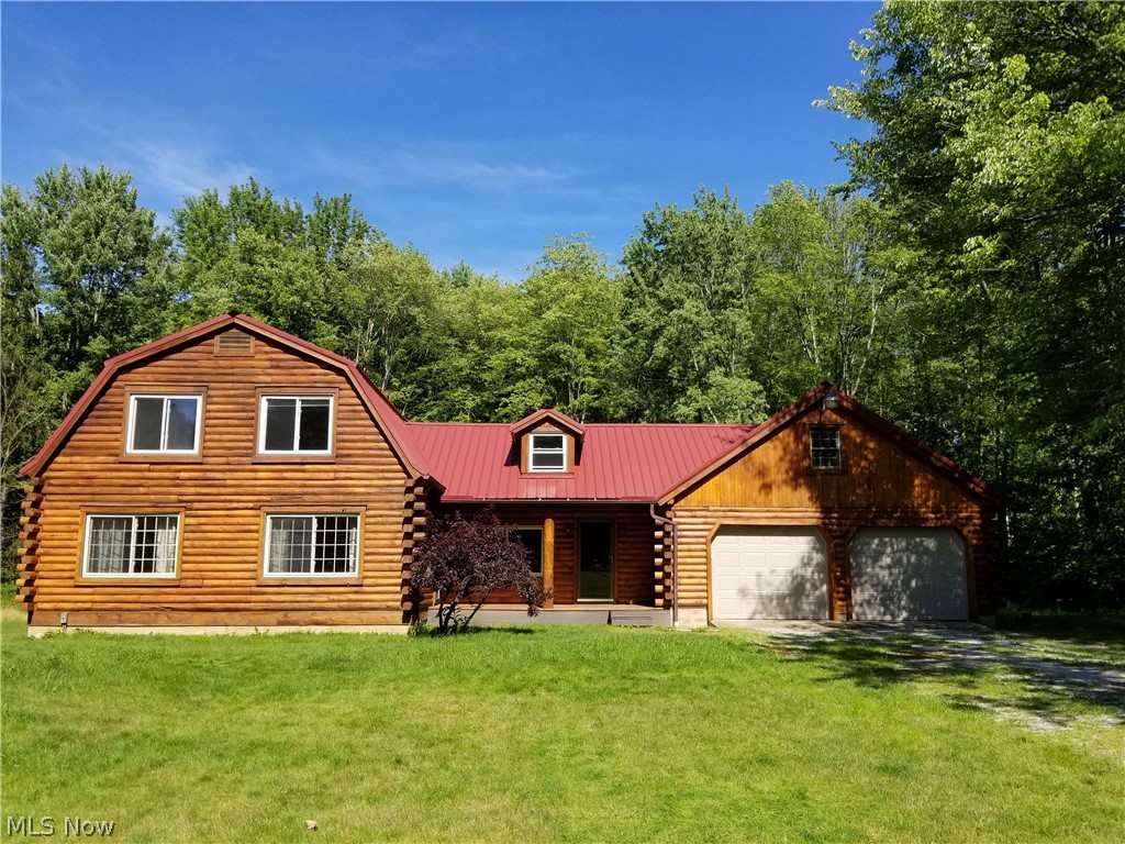 Log Home on a private lot - 1.32 Acres!  Home features an updated eat-in Kitchen with oak cabinets & ceramic tile floor, Formal Dining Room, Formal Living Room with wood burner, 2 full baths, 3 bedrooms, 2 car garage, full basement.  New metal roof, new entrance doors, New pressure tank + more!  Taste of Country yet close to town!