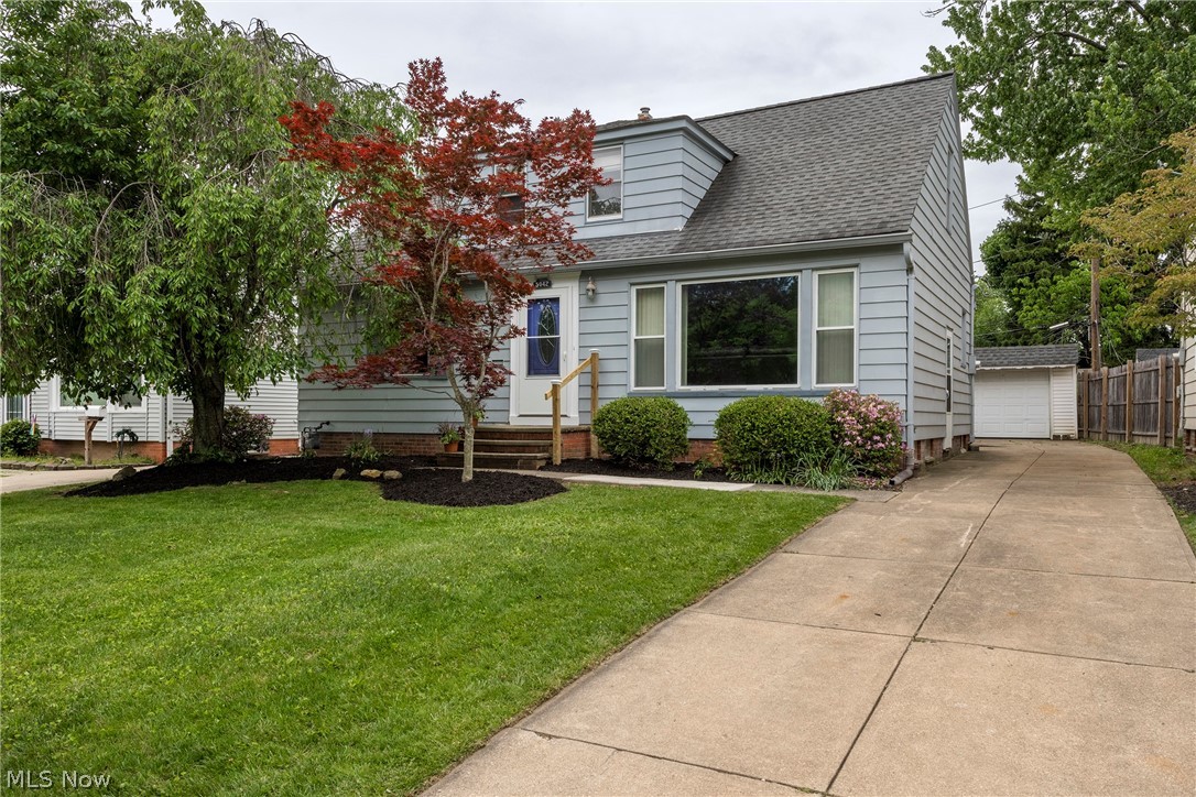Welcome to 5042 N Barton Rd in Lyndhurst, a spacious and inviting family home offering more space than meets the eye. A standout feature is the first-floor primary bedroom with double closets, a full bathroom, and a large first floor laundry room for added convenience. Enjoy the charming front garden and mature trees as you arrive. Inside, the generous living room features hardwood floors and a wall of windows that fills the home with natural light and flows seamlessly into the dining room, sunroom, and newer remodeled kitchen with granite countertops, a newly installed glass tile backsplash, a new faucet, brand new appliances, and excellent lighting throughout. Many rooms have been freshly painted, adding to the home's move in ready appeal. Upstairs, you will find four additional bedrooms, including one currently staged as an office and another that is perfect for a nursery or flexible living space, along with a full bathroom featuring a shower. Most bedrooms have hardwood floors, and several include charming built ins. The front and side entrances have new storm doors. The finished lower level offers a spacious recreation room with carpeting, additional space for workouts or play, and rubber foam tiles ready for future updates. The workshop and utility area includes a newer HVAC system installed in 2024, a hot water tank installed in 2026, updated electrical, and a freezer, cabinets, and tables that will remain with the home. Outside, enjoy a patio, a generously sized backyard ideal for entertaining or gardening, and a one car detached garage with a new garage door opener, plus a long driveway with parking for at least four vehicles. Located in the South Euclid Lyndhurst School District and close to the Metroparks, shopping, restaurants, the library, and more, this wonderful home is ready for its next owners. Schedule your private tour today.