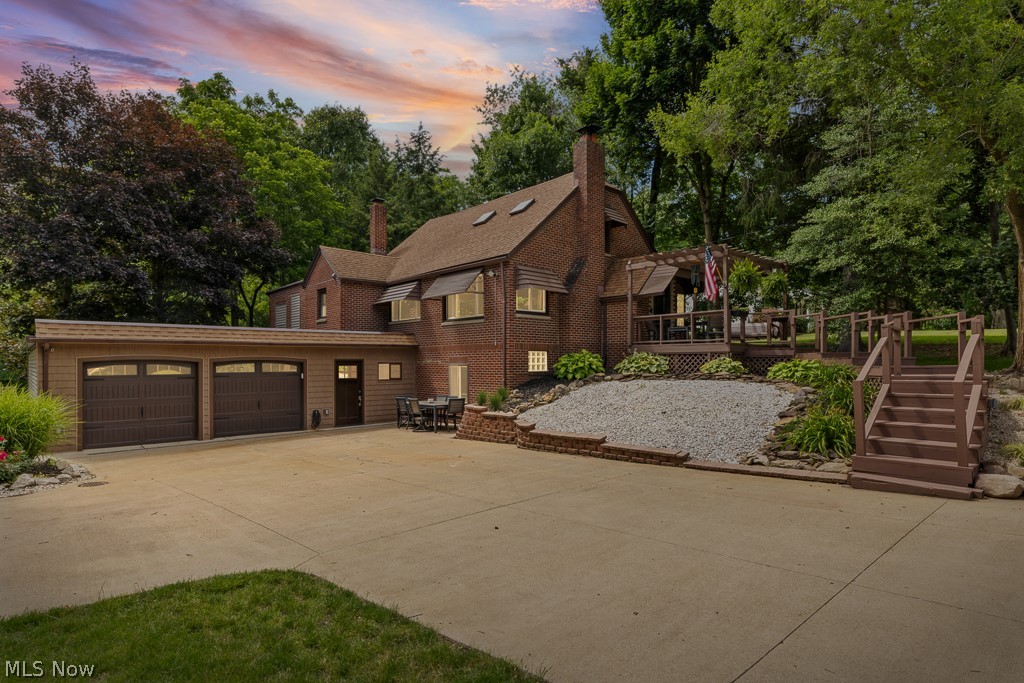 Welcome home to this truly one-of-a-kind Cape Cod nestled on a picturesque 0.82-acre lot! Offering over 2,000 square feet of beautifully updated living space, 3 bedrooms, 2 full baths, and a 2-car attached garage, this property combines modern updates with timeless charm. A welcoming pergola-covered front porch sets the tone as you enter this meticulously maintained home featuring luxury vinyl flooring and stylish finishes throughout. The spacious living room offers an inviting gathering space, while the dining area showcases a stunning stone fireplace that creates warmth and character. The heart of the home is the dream kitchen, thoughtfully remodeled with quartz countertops, KraftMaid soft-close cabinetry, stainless steel appliances, a glass tile backsplash, a commercial-grade 5-burner gas range, and convenient counter seating perfect for casual meals and entertaining. The main level also includes two generously sized bedrooms and a beautifully updated full bath. Upstairs, you'll find a private third bedroom complete with a skylight, creating a bright and relaxing retreat. The finished walkout lower level provides exceptional additional living space. Enjoy a spacious recreation room with a stone fireplace, bar with granite countertops, a dry bar/kitchen area with seating, a full bath, a private laundry room, and a versatile flex space ideal for a home office or hobby room. Outside the property opens to a scenic setting with mature trees and a playground area, providing plenty of space to relax and enjoy the outdoors. Easy-maintenance landscaping adds to the home's impressive curb appeal. Numerous updates including an updated septic system, garage roof, pressure tank, furnace, central air, rebuilt front porch, updated 200-amp electrical service, vinyl windows, fiber optic internet availability, and many additional improvements throughout. This immaculate property is truly move-in ready and offers the perfect blend of comfort, style, and space both inside and out.