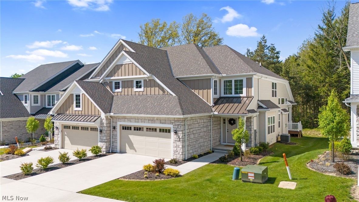 Welcome to refined luxury living at The Villas at City Center in the heart of Broadview Heights. Built in 2025 by premier local builder Petros Homes, this stunning townhome showcases exceptional craftsmanship and inviting curb appeal with its attractive exterior and covered front porch. The bright, open-concept floor plan is designed for modern lifestyles, featuring luxury vinyl wood plank flooring, soaring ceilings, and a dramatic Great Room with a cozy gas fireplace. The chef’s kitchen is a true centerpiece, boasting custom cabinetry, quartz countertops, a large center island, upscale appliances, and a walk-in pantry. For seamless indoor/outdoor living, the Great Room opens directly to a charming rear porch.

The first-floor owner’s suite provides the convenience of single-level living, complete with a spa-inspired en-suite bath featuring dual vanities, a luxury walk-in shower, and an oversized walk-in closet. Practicality is built-in with a spacious first-floor laundry room and mudroom. Upstairs, a versatile open loft offers the perfect space for a home office or media room, alongside two additional generously sized bedrooms and a full bath. For those needing more space, the full 12-course unfinished basement is already roughed-in for future finishing.

Located in the highly rated Brecksville-Broadview Heights School District, this home offers a maintenance-free lifestyle with HOA-covered landscaping and snow removal. You are perfectly positioned near the Metro Parks, Cuyahoga Valley National Park, and local dining, with easy access to I-77 for quick commutes to Downtown Cleveland and Akron. This exceptional home is in move-in condition, supported by a pre-listing inspection report and a one-year seller-provided home warranty. Schedule your private tour today!
